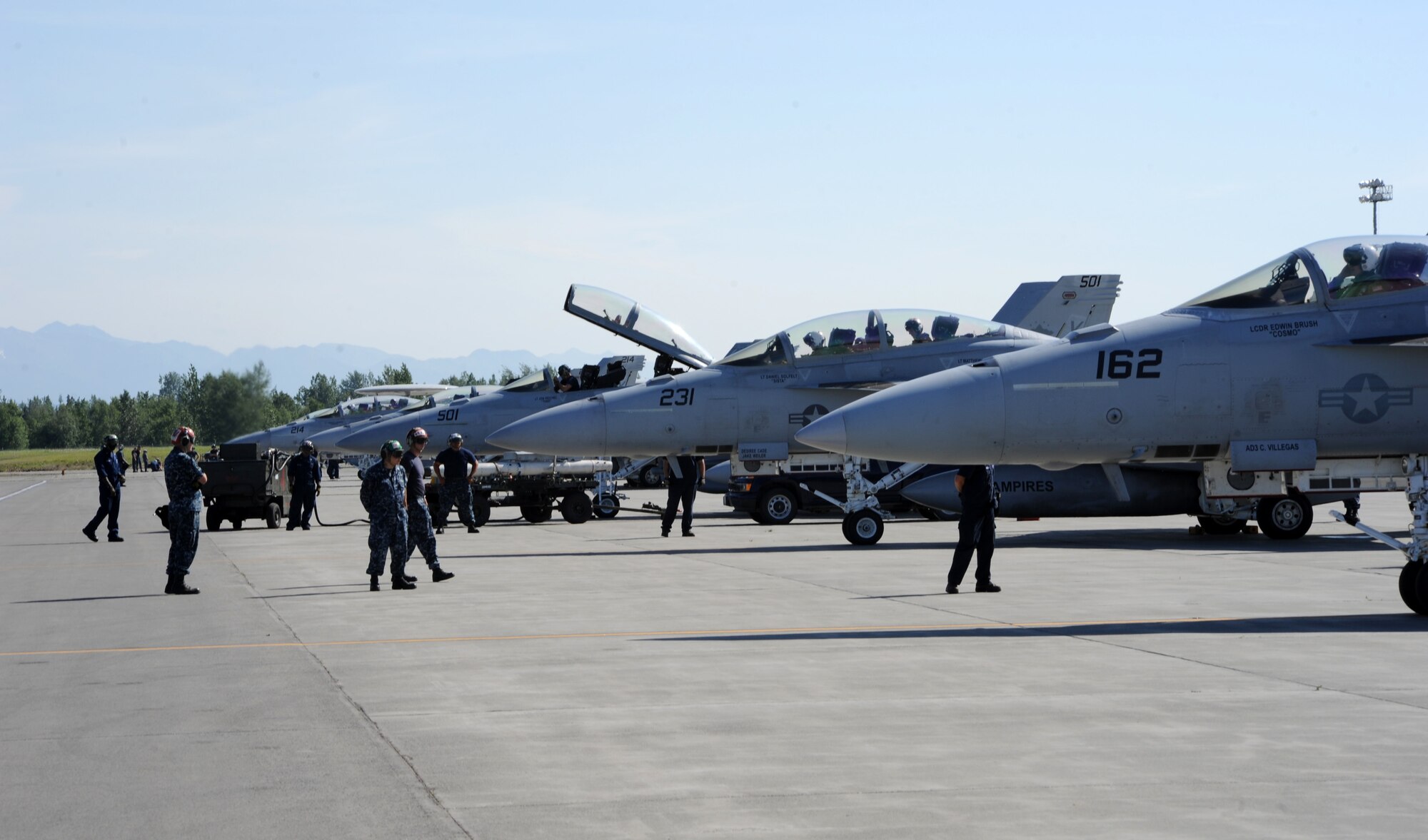 Crew members prepare a U.S. Navy F/A-18F Super Hornet from Air Test Squadron, China Lake, California,  prepare aircraft to launch for a mission during Exercise Northern Edge 15 from Joint Base Elmendorf-Richardson, Alaska, June 19, 2015. Northern Edge 15 is Alaska’s premier joint training exercise designed to practice operations, techniques and procedures as well as enhance interoperability among the services. Thousands of participants from all services, from active duty, Reserve and National Guard units, are involved. (U.S. Air Force photo by Staff Sgt. William Banton/Released)‪