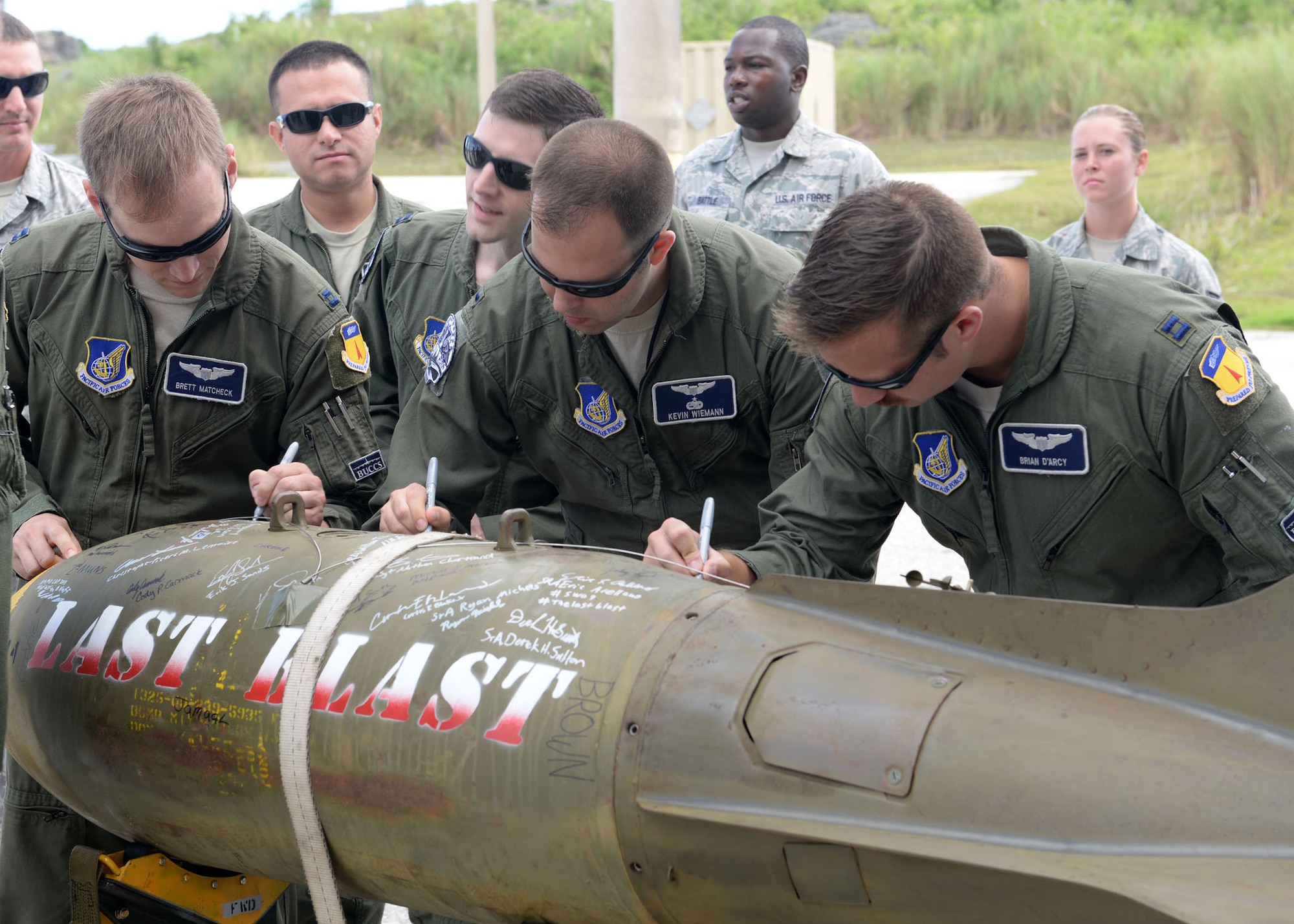 U.S. Air Force Airmen from the 20th Expeditionary Bomb Squadron sign the ‘Last Blast’ June 24, 2015, at Andersen Air Force Base, Guam. With the help of 36th Munitions Squadron Airmen, 20th EBS aircrew dropped the final M117 bomb in the Pacific Air Force’s inventory June 26 on an uninhabited island off the coast of Guam. (U.S. Air Force photo by Airman 1st Class Joshua Smoot/Released)
