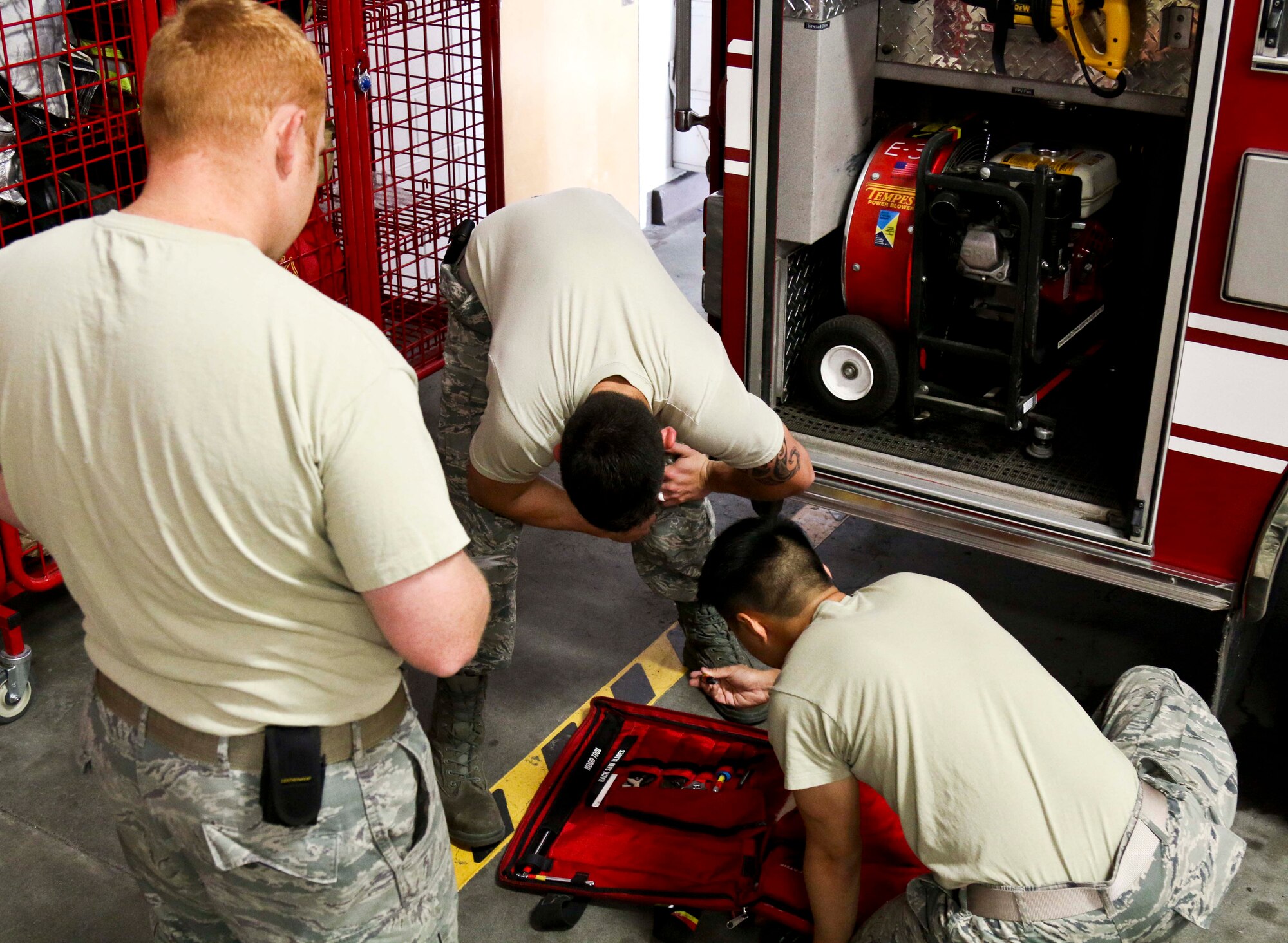 U.S. Air Force Staff Sgt. Jeremy Jones (left), 673rd Civil Engineer Squadron crew chief, checks behind his crew as part of their morning checks during Exercise Northern Edge 2015 at Joint Base Elmendorf-Richardson, Alaska, June 23, 2015. NE15is Alaska’s premier joint training exercise designed to practice operations, techniques and procedures as well as enhance interoperability among the services. Thousands of participants from all services, from active duty, Reserve and National Guard units are involved. (U.S. Army photo by Sgt. Brian Ragin/Released)