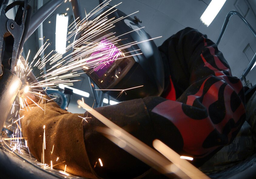 U.S. Air Force Airman 1st Class Curtis Doherty, 374th Maintenance Squadron aircraft metals technology journeyman, welds a post hole for a B-1 platform at Yokota Air Base, Japan, June 23, 2015. The average time it takes to fix or create a piece of equipment is approximately eight hours. (U.S. Air Force photo by Senior Airman David Owsianka/Released)