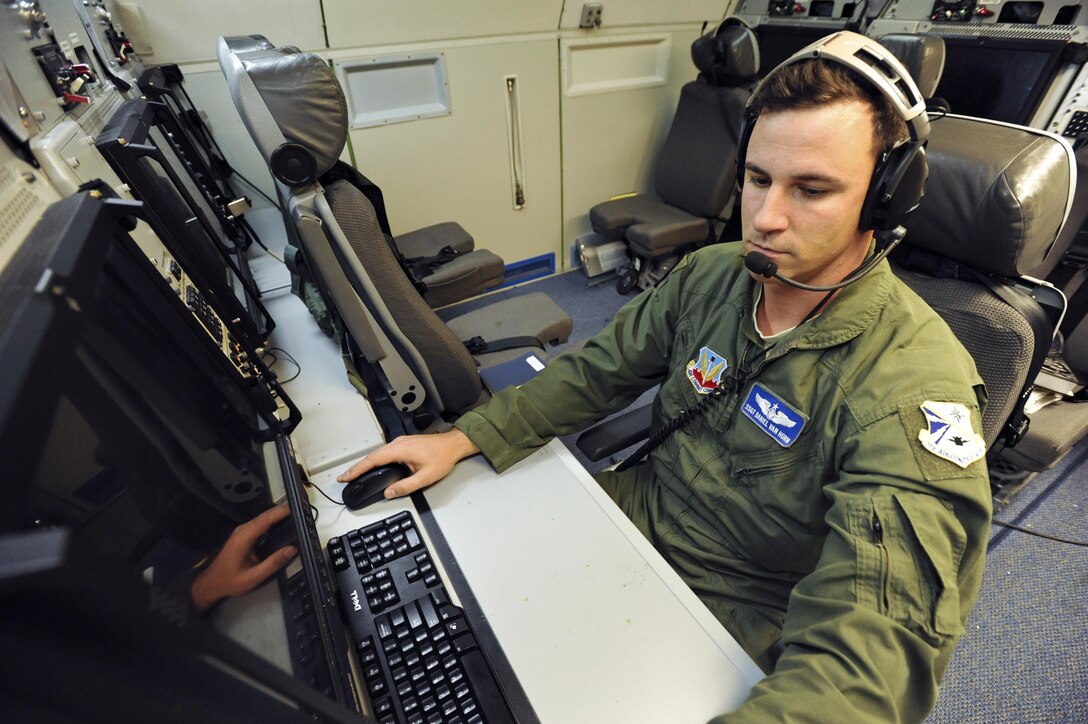 U.S. Air Force Staff Sgt. Daniel Van Horn, 966th Airborne Air Control Squadron, Oklahoma City, an airborne surveillance technician on an E-3G Airborne Warning and Control System aircraft, prepares for a mission above the Joint Pacific Alaska Range Complex during Exercise Northern Edge June 25, 2015. Thousands of service members from all the branch services including active duty, Reserve and National Guard units participated. (U.S. Air Force photo by Staff Sgt. William Banton/Released)