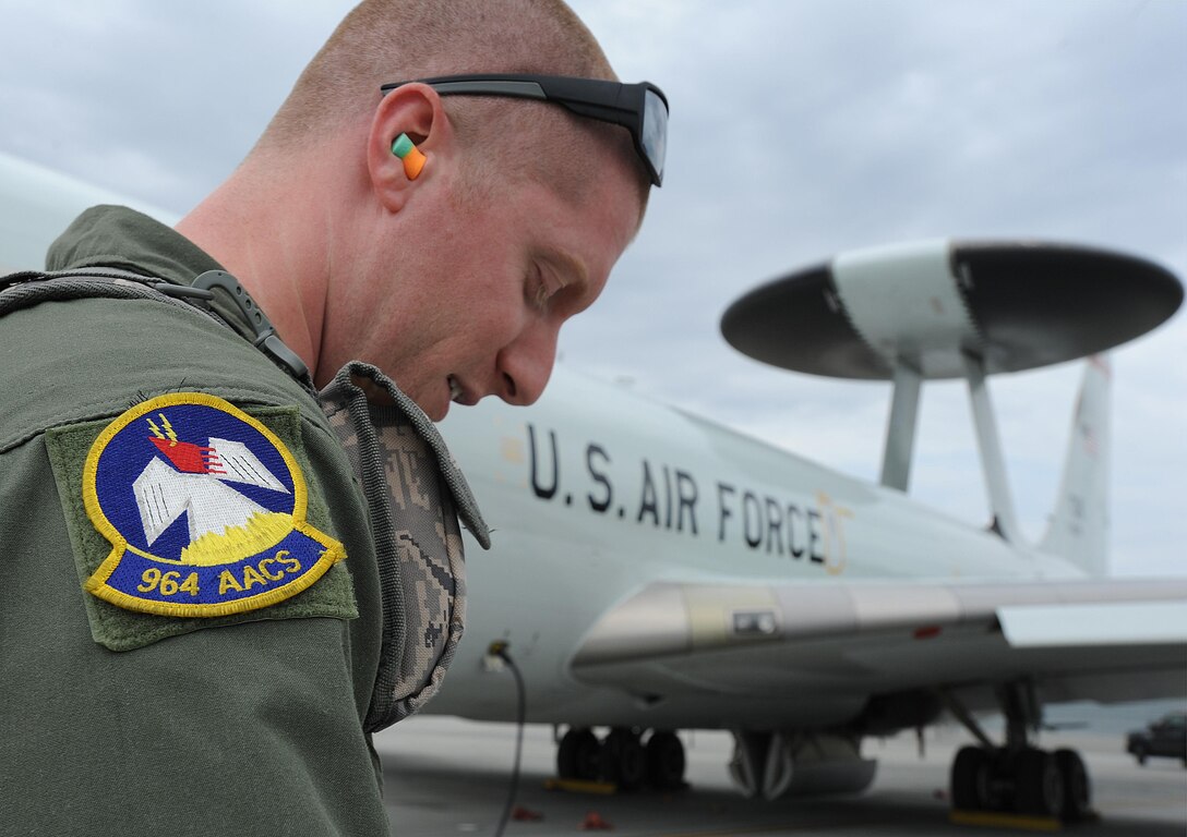 U.S. Air Force Staff Sgt. Greg Pfeffer, a flight engineer for the 964th Airborne Air Control Squadron, Oklahoma City, on an E-3G Airborne Warning and Control System aircraft, is pictured after a mission above the Joint Pacific Alaska Range Complex during Exercise Northern Edge June 25, 2015. Thousands of service members from all the branch services including active duty, Reserve and National Guard units participated. (U.S. Air Force photo by Staff Sgt. William Banton/Released)
