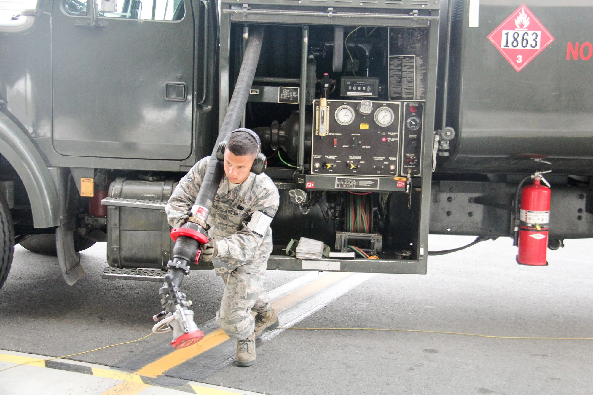 U.S. Air Force Airman 1st Class Sengchanh Seuam, 673rd Logistics Readiness Squadron fuel distribution operator,  prepares to refuel a F-22 Raptor during Exercise Northern Edge June 25, 2015. Over 200 military aircraft from all services practiced operations, techniques and procedures while simultaneously enhancing interoperability during Exercise Northern Edge 2015, Alaska’s premier joint training exercise. (U.S. Navy photo by Lt. Edward Cartagena/Released)