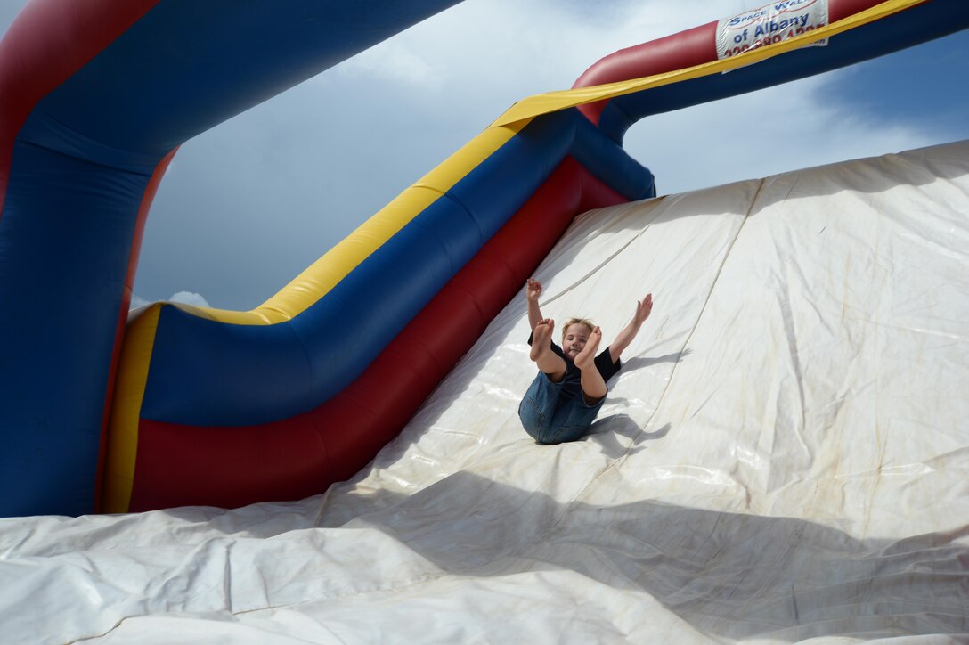 A child slides down a bouncy house during the Independence Day celebration, June 26, held at Marine Corps Logistics Base Albany.
