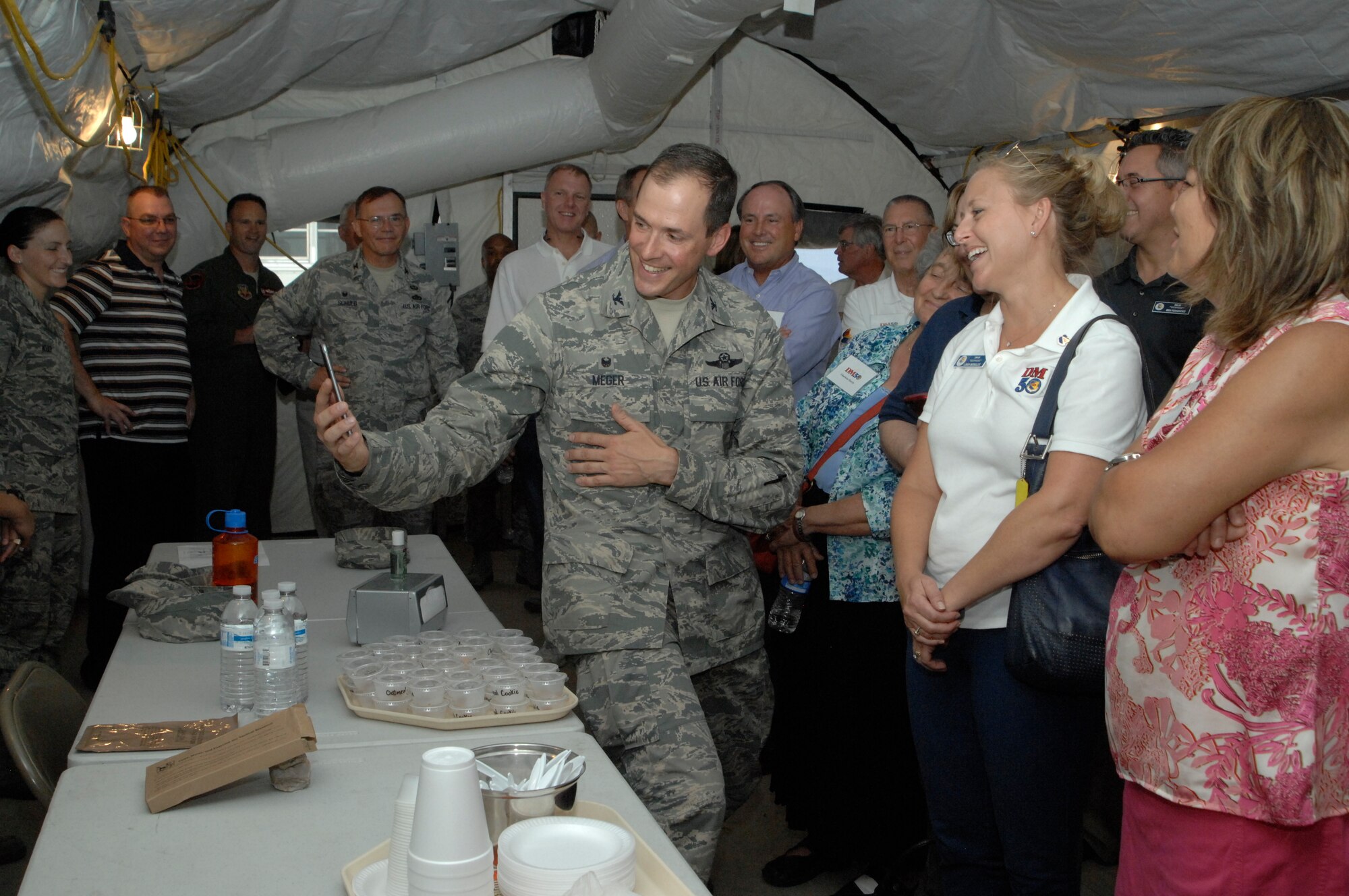 U.S. Air Force Col. James Meger, 355th Fighter Wing commander, conducts a 
video call with a family member demonstrating to the DM-50 how they would 
communicate with family while deployed during an immersion tour at 
Davis-Monthan Air Force Base, Ariz., June 25, 2015. DM-50 is a non-profit 
organization comprised of civic leaders that assist in bridging the 
relationship between D-M and the surrounding community. (U.S. Air Force photo 
by Airman 1st Class Ashley N. Steffen)

