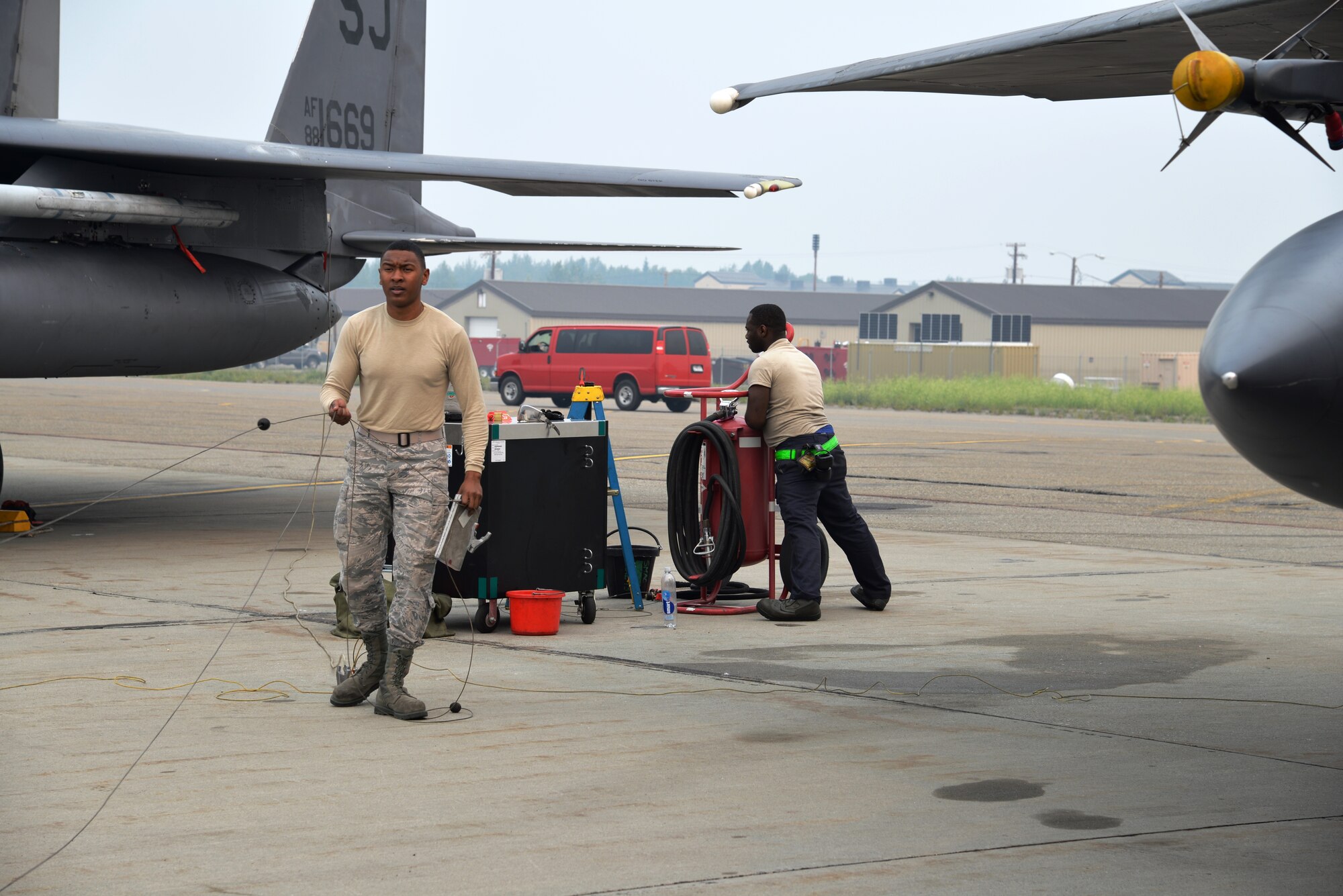 EIELSON AIR FORCE BASE, Alaska -- U.S. Air Force Airman 1st Class Anthony Jackson, a fuels management technician from the 18th Logistics Readiness Squadron, Kadena Air Base, Japan, puts static lines away after re-fueling an F-15 Eagle June 23, 2015, at Eielson Air Force Base, Alaska. The fuel truck, an R-11, can hold approximately 6,000 gallons of fuel. Northern Edge 2015 is Alaska’s premier joint training exercise designed to practice operations, techniques and procedures as well as enhance interoperability among the services. Thousands of participants from all the services, Airmen, Soldiers, Sailors, Marines and Coast Guardsmen from active duty, Reserve and National Guard units are involved. (U.S. Air Force photo by Staff Sgt. Kirsten Wicker/Released)  