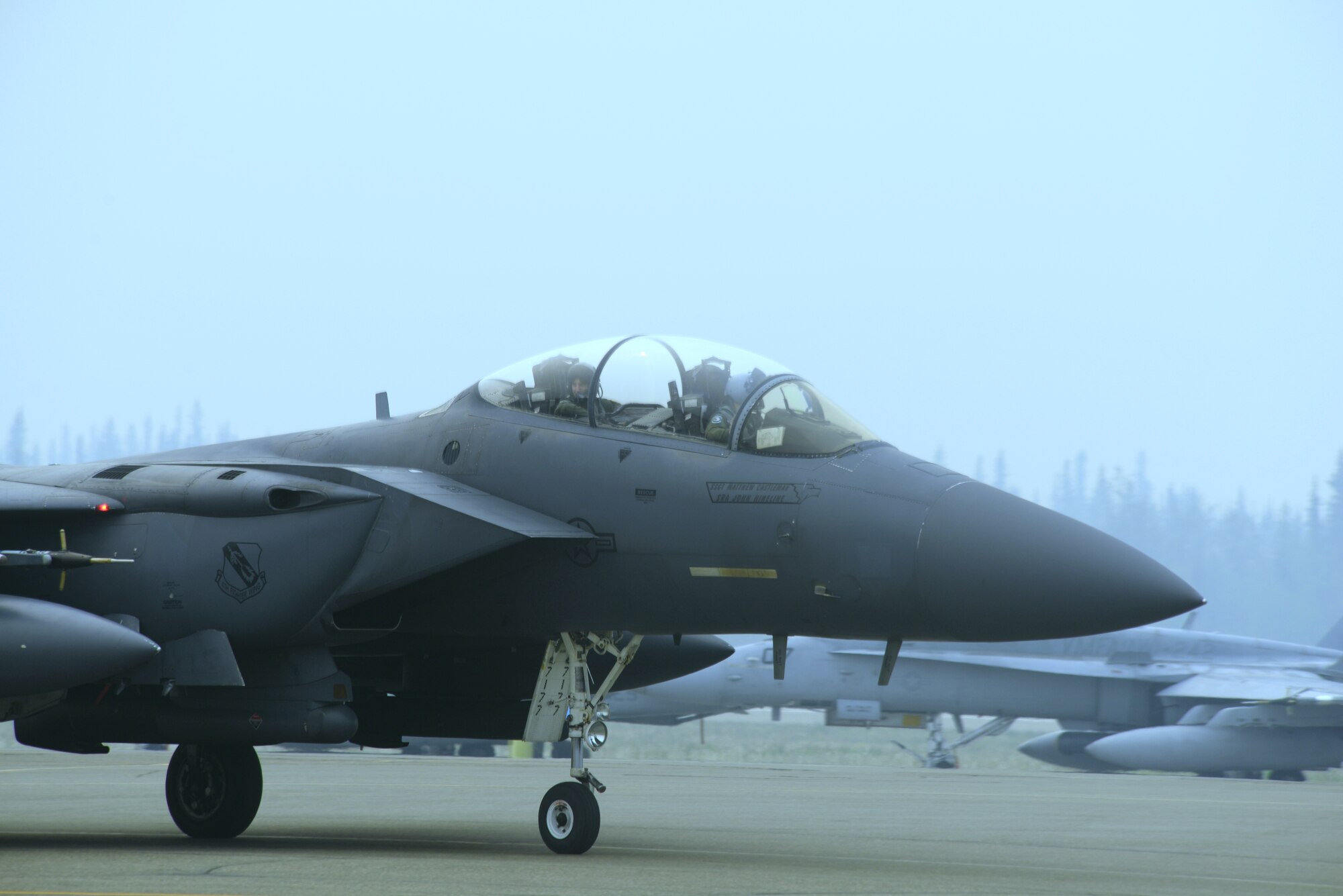 EIELSON AIR FORCE BASE, Alaska -- A U.S. Air Force F-15 Eagle from the 4th Fighter Wing, Seymour-Johnson Air Force Base, N.C., taxis to a parking spot after a morning sortie June 23, 2015, at Eielson Air Force Base, Alaska. Maintenance crews immediately begin bed-down procedures, while the fuel truck stands by to re-fuel the jet. Northern Edge 2015 is Alaska’s premier joint training exercise designed to practice operations, techniques and procedures as well as enhance interoperability among the services. Thousands of participants from all the services, Airmen, Soldiers, Sailors, Marines and Coast Guardsmen from active duty, Reserve and National Guard units are involved. (U.S. Air Force photo by Staff Sgt. Kirsten Wicker/Released)  