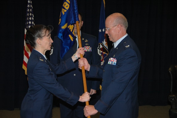 Col. (Dr.) Paul J. Hoerner accepts the 61st Medical Squadron ceremonial guidon from Col. Donna Turner, 61st Air Base Group commander during an assumption of command ceremony June 26 at the Gordon Conference Center. Hoerner becomes the newest commander of the 61st MDS, responsible for ensuring more than 1,200 active duty personnel assigned to the Space and Missile Systems Center at Los Angeles Air Force Base, are medically fit and ready for contingency (natural disasters and wartime) operations. He commands a staff of 178 active duty, government civilians and contract medical staff providing care for more than 171,000 eligible patients across the greater Los Angeles metropolitan area. (U.S. Air Force photo/Jim Spellman)