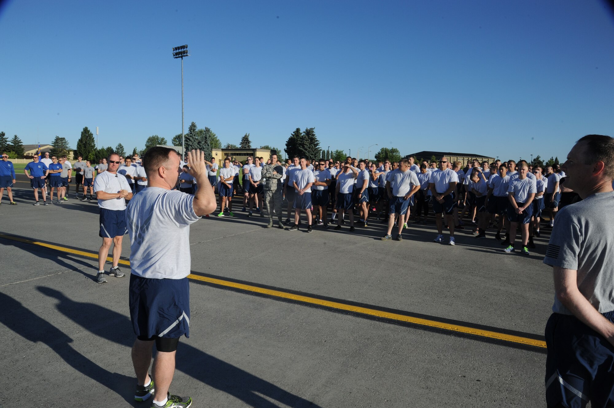 Col. Brian McDaniel, 92nd Air Refueling Wing commander, addresses Airmen prior to the commencement of the wing run June 26, 2015, at Fairchild Air Force Base, Wash. The monthly fun run was held on the flightline. Wing runs encourage team morale and welfare through a shared goal. (U.S. Air Force photo/Senior Airman Sam Fogleman)