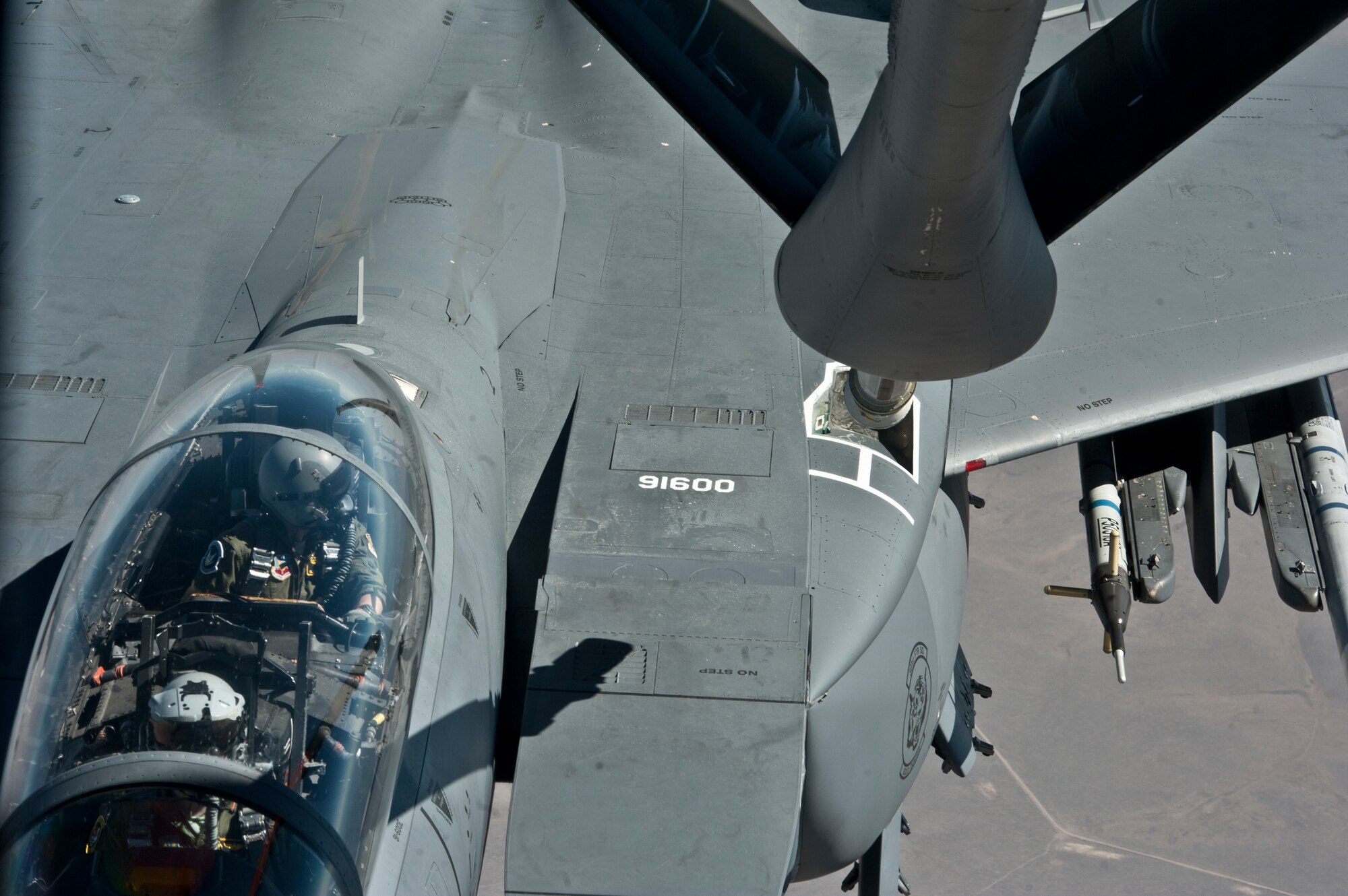 A pilot flying a F-15E Strike Eagle from Mountain Home Air Force Base, Idaho, looks over as a KC-135 Stratotaker from Fairchild AFB, Wash., prepares to refuel it during a mission June 25, 2015 over the Inland Northwest. The KC-135 Stratotanker provides the core aerial refueling capability for the United States Air Force and has excelled in this role for more than 50 years. (U.S. Air Force photo/Staff Sgt. Veronica Montes)
