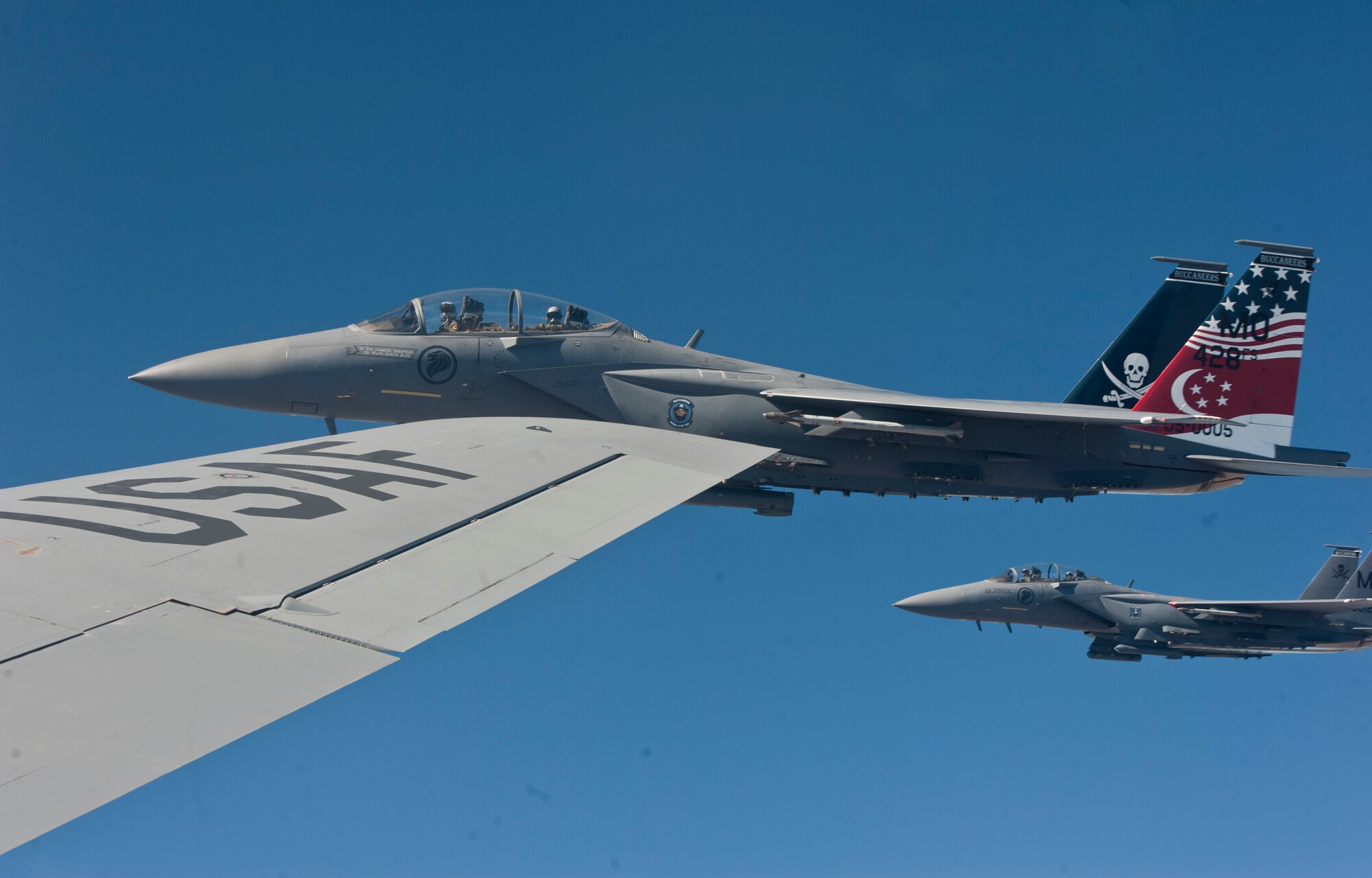 Two F-15E Strike Eagles from Mountain Home Air Force Base, Idaho, fly alongside the wing of a KC-135 Stratotanker from Fairchild AFB, Wash., during a refueling mission June 25, 2015, over the Inland Northwest.  During the mission some of the F-15E Strike Eagles were flown by Republic of Singapore Air Force pilots in training as well as American pilots. (U.S. Air Force photo/Staff Sgt. Veronica Montes)