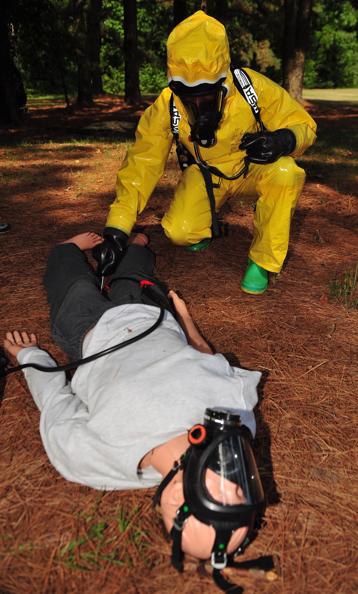 Maj. Michael Smith, 4th Aerospace Medicine Squadron bioenvironmental engineering flight commander, retrieves a simulated sample of Staphylococcal Enterotoxin B from a training body during an integrated base emergency response capabilities training exercise, June 25, 2015, at Seymour Johnson Air Force Base, North Carolina. IBERCT was a weeklong training exercise that consisted of classroom instruction and response scenarios. (U.S. Air Force photo/Senior Airman John Nieves Camacho)