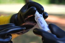 Maj. Michael Smith, left, 4th Aerospace Medicine Squadron bioenvironmental engineering flight commander, and Tech. Sgt. Jessica Clayton, 4th Civil Engineer Squadron emergency management plans section NCO in charge, recover a simulated dose of Staphylococcal Enterotoxin B during an integrated base emergency response capabilities training exercise, June 25, 2015, at Seymour Johnson Air Force Base, North Carolina. IBERCT offered a joint training environment to help refine response skills for multiple units on base. (U.S. Air Force photo/Senior Airman John Nieves Camacho)