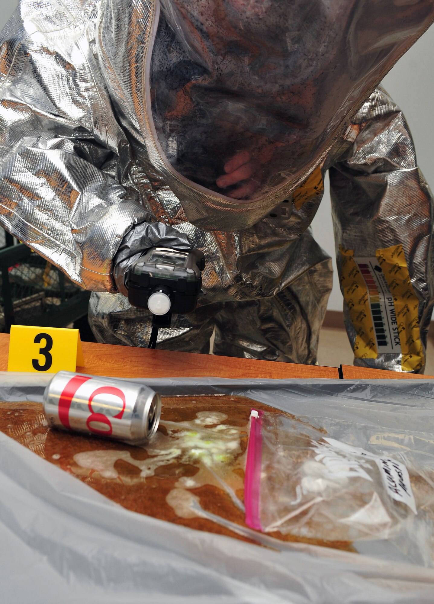 Tech. Sgt. Jessica Clayton, 4th Civil Engineer Squadron emergency management plans section NCO in charge, scans for harmful substances during an integrated base emergency response capabilities training exercise, June 24, 2015, at Seymour Johnson Air Force Base, North Carolina. IBERCT is an annual exercise conducted by Air Combat Command that teams together emergency management and bioenvironmental flights to practice responding to real world chemical, biological, radiation and nuclear threats. (U.S. Air Force photo/Senior Airman John Nieves Camacho)