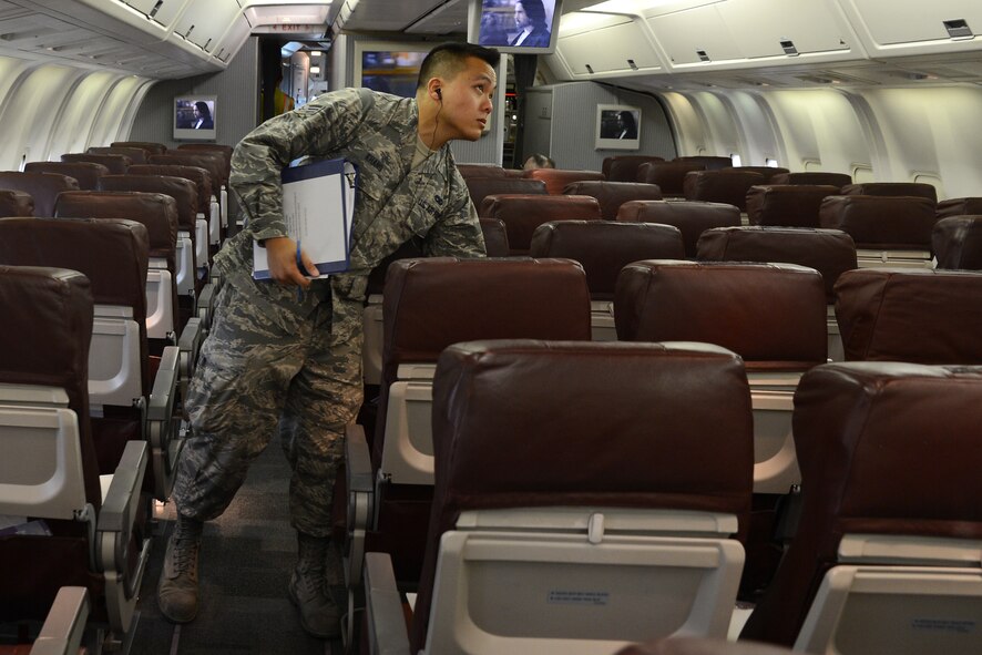 Senior Airman Pao Khang, 62nd Aerial Port Squadron contracting officer representative, checks the audio ports on a contracted flight, June 16, 2015, at SeaTac Airport, Wash., for military members traveling overseas. Khang and the other Airmen from the 62nd APS, assigned to SeaTac are responsible for ensuring contractors adhere to the terms of their contracts. (U.S. Air Force photo by Staff Sgt. Tim Chacon)