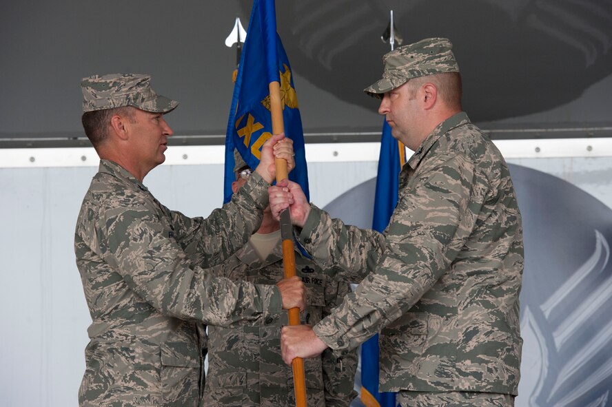U.S. Air Force Col. Chad Franks, 23d Wing commander, hands the 23d Maintenance Group guidon to the new 23d MXG commander Col. Shane Barrett during a change of command ceremony June 25, 2015, at Moody Air Force Base, Ga. The passing of the guidon is symbolic of a new commander taking command of a squadron, group or wing. (U.S. Air Force photo by Andrea Jenkins/Released)


