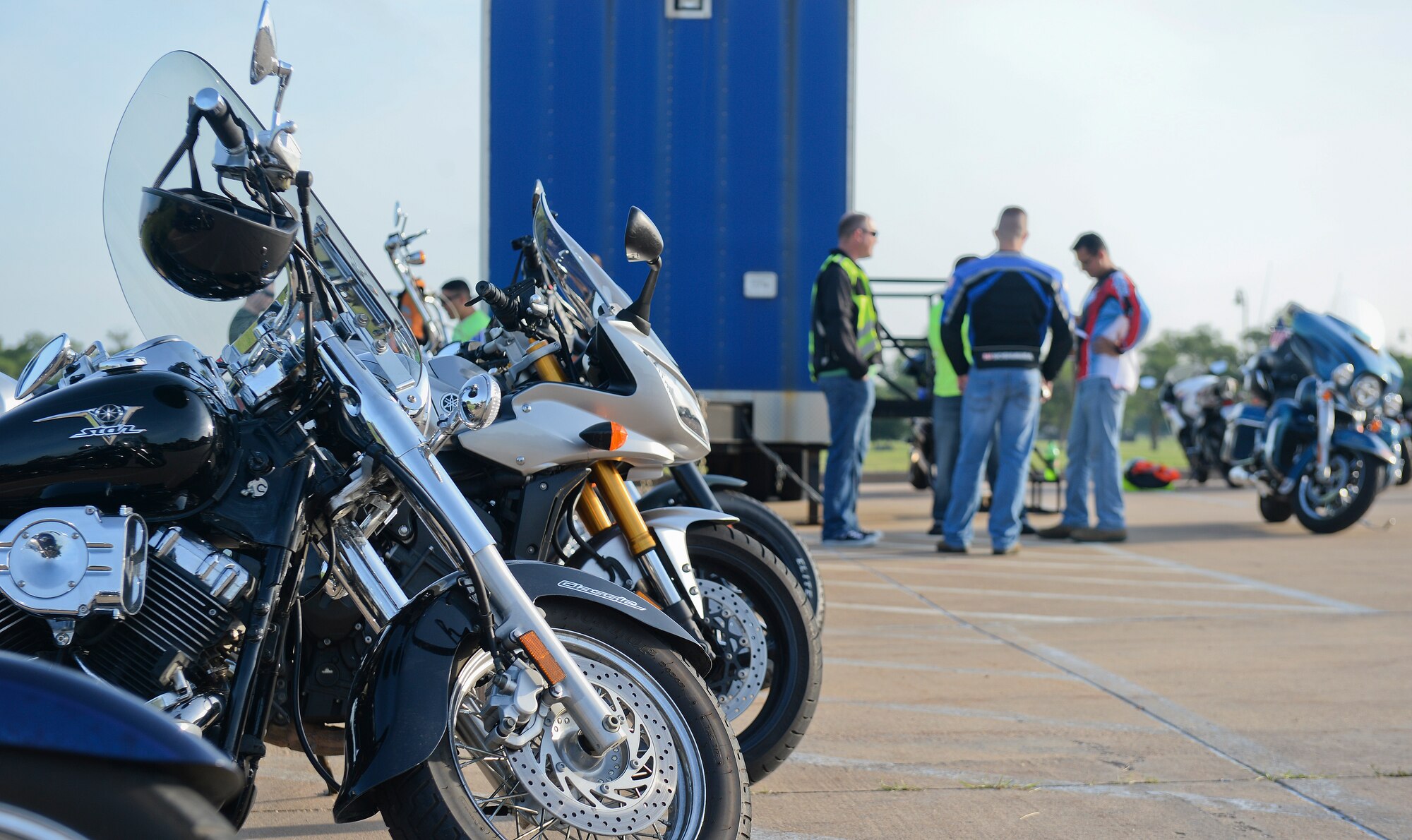 A group of Airmen talk about riding strategies before taking off on the mentor ship ride June 19, 2015, at McConnell Air Force Base, Kan. The mentorship ride was to recertify riders who have already taken the advanced riders course. (U.S. Air Force photo by Senior Airman Colby L. Hardin)