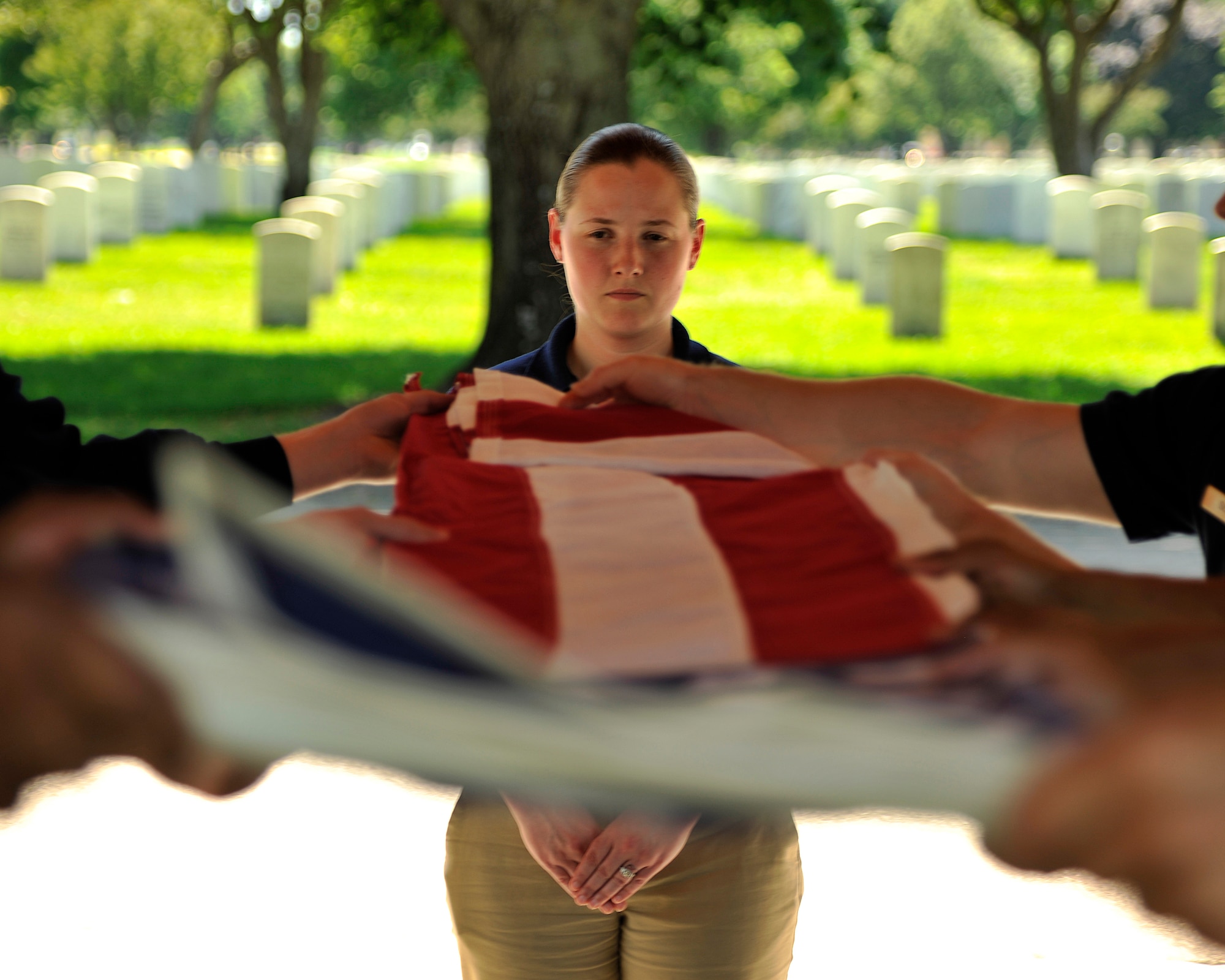 Staff Sgt. Alexandra Crawley, 319th Force Support Squadron Honor Guard program manager, supervises a six-man flag fold practice June 21, 2015, at Fort Snelling National Cemetery, Minn. The 319th Air Base Wing Honor Guard traveled to Minneapolis, Minn., to honor U.S. Air Force Maj. Rober Olson, who passed away on Feb. 5, 1969, while serving in Vietnam. (U.S. Air Force photo by Senior Airman Xavier Navarro/released)