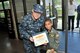 Lt. Cmdr. Christopher Briem, acting commanding officer of the Navy Operational Support Center – Pittsburgh, presents Air Force honorary 2nd Lt. Trenton Bentley with a certificate of promotion to Navy Honorary Lt. Surface Warfare Officer here, June 24, 2015. Trenton, who was diagnosed with acute lymphoblastic leukemia in December 2014, was nominated by Children’s Hospital of Pittsburgh to be the 911th Airlift Wing’s second ever Pilot for a Day. (U.S. Air Force photo by Senior Airman Marjorie A. Bowlden)