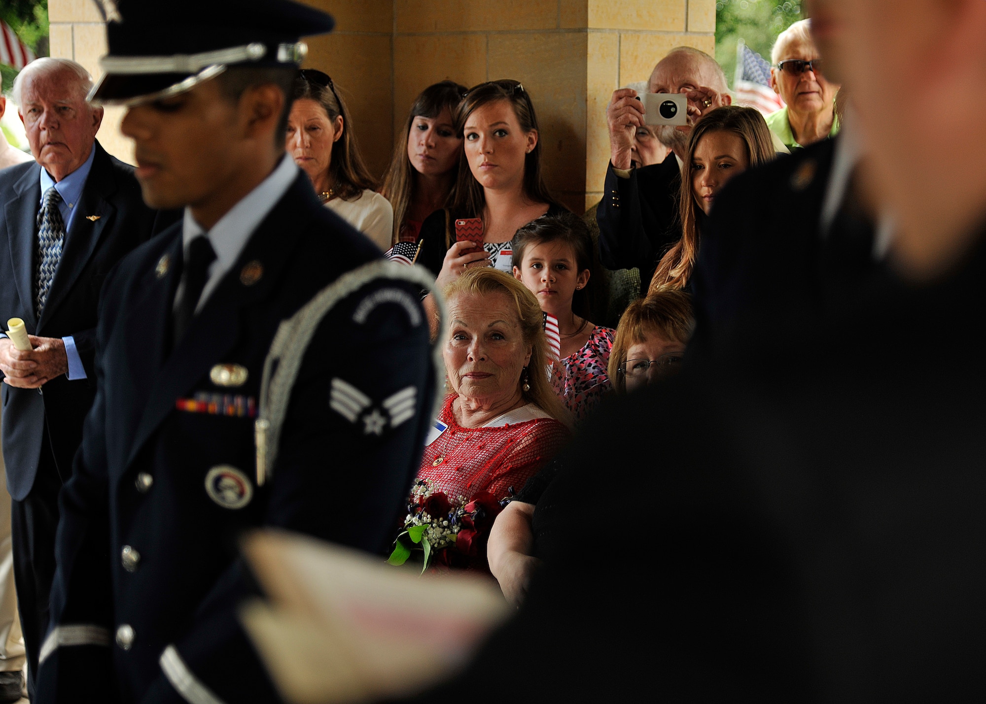 Mary Kay Olson, widow of Maj. Robert Olson, watches members of the 319th Air Base Wing Honor Guard during a six-man flag fold to honor the Vietnam War veteran at Fort Snelling National Cemetery, Minn. June 22, 2015. Olson's provided DNA samples to help  identify Olson's remains in order to allow a proper burial. (U.S. Air Force photo by Senior Airman Xavier Navarro/released)