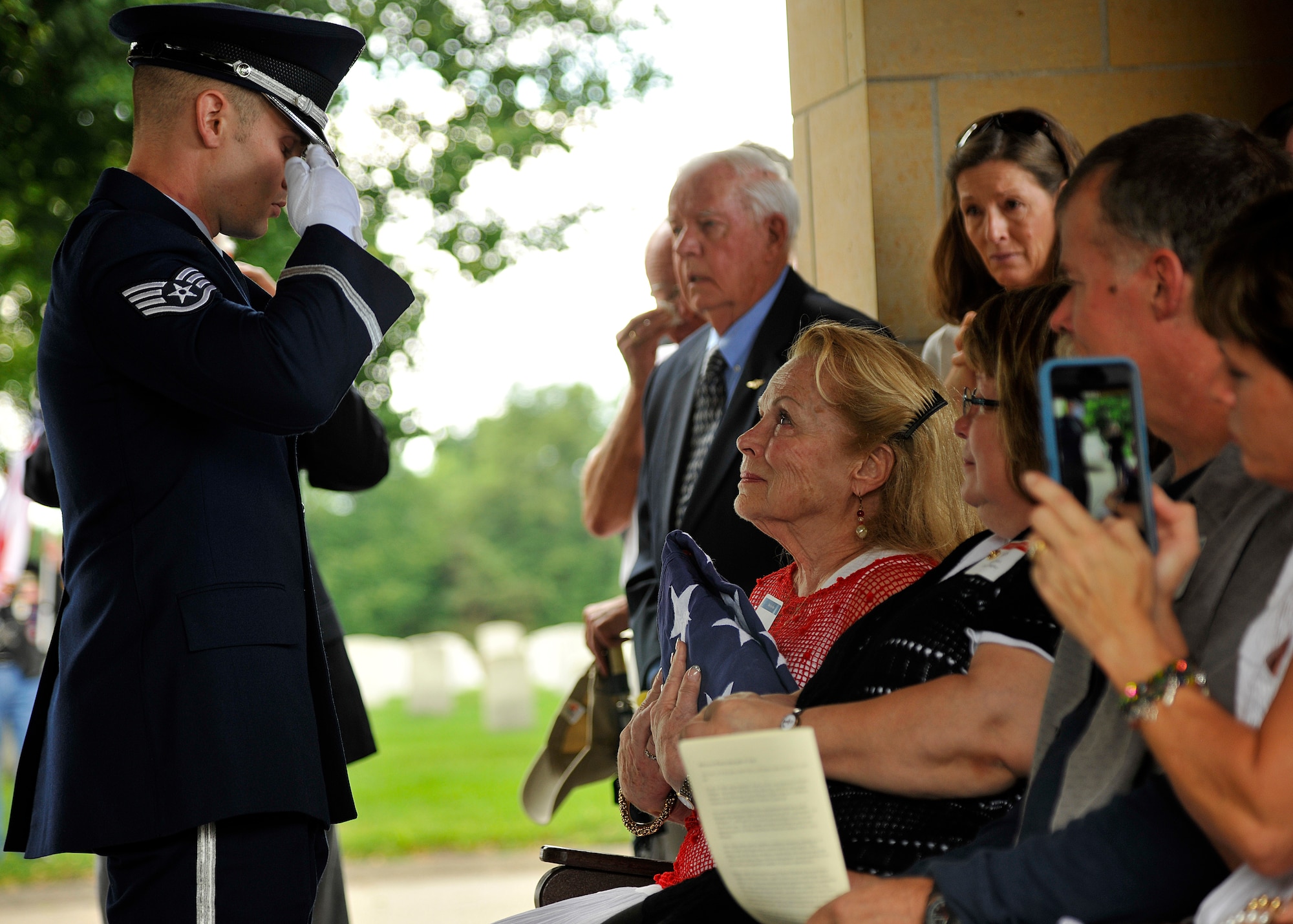 Staff Sgt. Robert Segler, 319th Air Base Wing Honor Guard ceremonial guardsman, gives the final salute to a flag presented to the widow of Maj. Robert Olson, U.S. Air Force veteran, on June 22, 2015 at Fort Snelling National Cemetery, Minn. Following DNA identification, Olson’s remains finally came home after 47 years to his wife and five children. (U.S. Air Force photo by Senior Airman Xavier Navarro/released) 