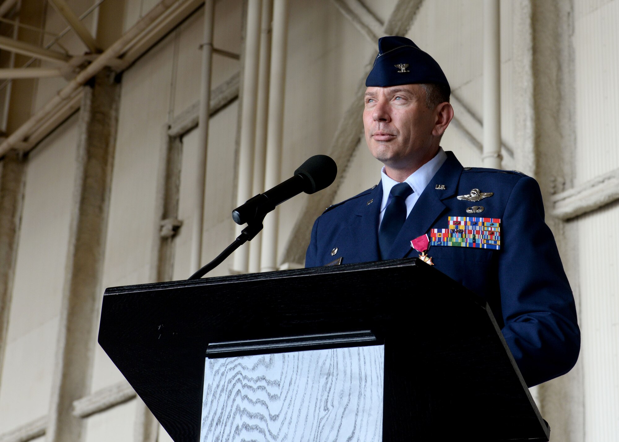 ALTUS AIR FORCE BASE, Okla. – U.S. Air Force Col. Bill Spangenthal, 97th Air Mobility Wing commander, speaks to members of the 97th AMW during his change of command ceremony at Hangar 517, June 26, 2015. Spangenthal served as the wing commander since June 2013 and transferred command to U.S. Air Force Col. Todd Hohn during the ceremony. (U.S. Air Force photo by Senior Airman Franklin R. Ramos/Released)