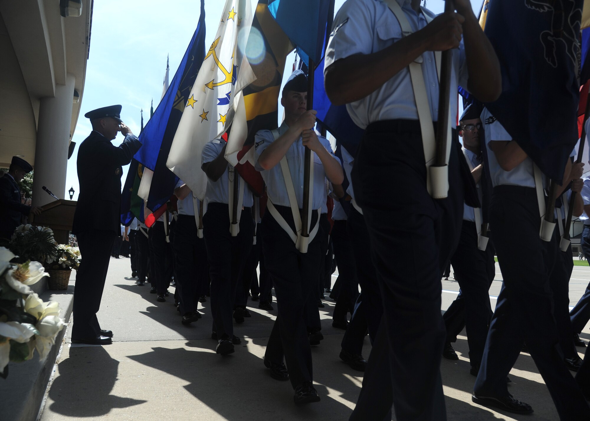 Brig. Gen. Patrick Higby, outgoing 81st Training Wing commander, salutes as members of the 336th Training Squadron carry the 50 state flags during pass and review at a change of command ceremony, June 26, 2015, Keesler Air Force Base, Miss. Col. Michele Edmondson, 81st TRW commander, took command of the 81st TRW from Higby. (U.S. Air Force photo by Senior Airman Holly Mansfield) 