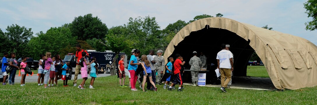 Team Andrews members line up for Operation KID Mode June 25, 2015, at Joint Base Andrews, Md. Operation KID Mode gives children and families of military members the opportunity to gain a greater understanding of what it means to deploy. (U.S. Air Force photo by Senior Airman Preston Webb)