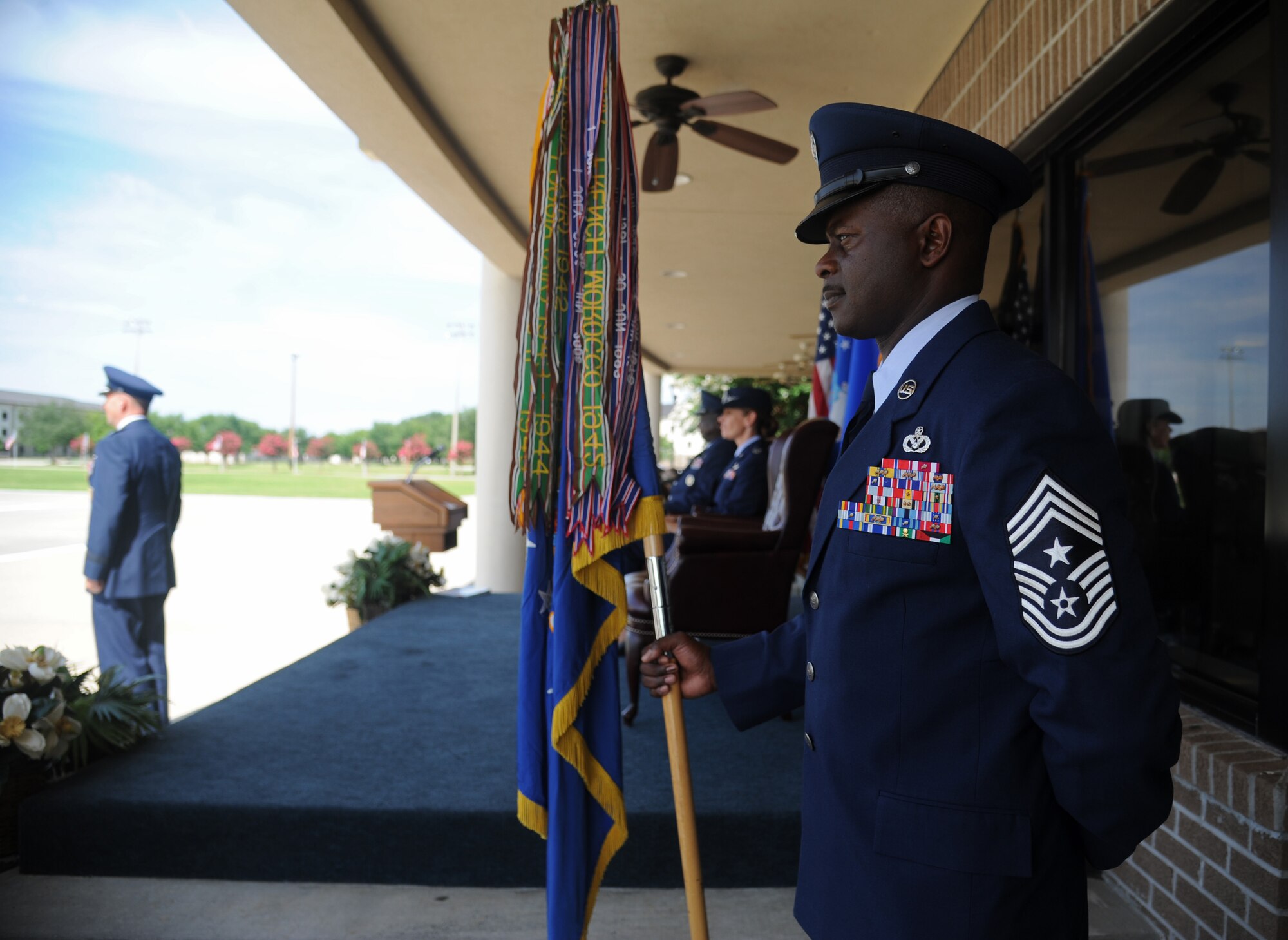 Chief Master Sgt. Harry Hutchinson, 81st Training Wing command chief, holds the guidon during a change of command ceremony, June 26, 2015, Keesler Air Force Base, Miss. The guidon ceremony is a symbol of command being exchanged from one commander to the next. Col. Michele Edmondson took command of the 81st TRW from Brig. Gen. Patrick Higby. (U.S. Air Force photo by Senior Airman Holly Mansfield)