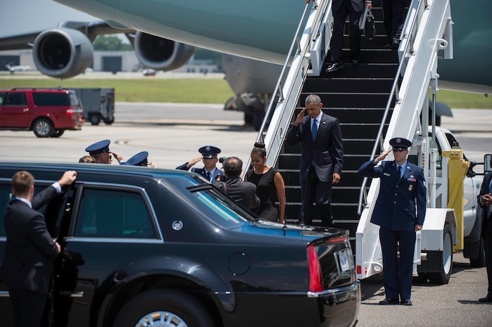 President Barack Obama arrives with First Lady Michelle Obama on the flightline June 26, 2015 at Joint Base Charleston, S.C. The President and First Lady attended the funeral services of Rev. Clementa Pinckney at the College of Charleston TD Arena, where President Obama delivered the eulogy. Vice President Joe Biden and Dr. Jill Biden also attended. Reverend Pinckney was one of nine people fatally shot June 17, 2015 week during a Bible study at Emanuel AME Church in Downtown Charleston. (U.S. Air Force photo/Senior Airman Jared Trimarchi) 