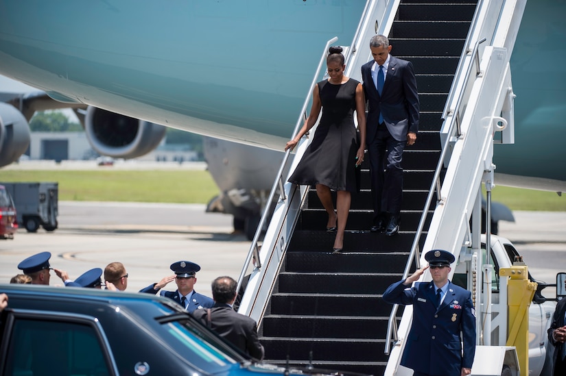 President Barack Obama arrives with First Lady Michelle Obama on the flightline June 26, 2015 at Joint Base Charleston, S.C. The President and First Lady attended the funeral services of Rev. Clementa Pinckney at the College of Charleston TD Arena, where President Obama delivered the eulogy. Vice President Joe Biden and Dr. Jill Biden also attended. Reverend Pinckney was one of nine people fatally shot June 17, 2015 week during a Bible study at Emanuel AME Church in Downtown Charleston. (U.S. Air Force photo/Senior Airman Jared Trimarchi) 