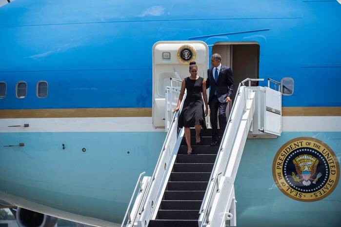 President Barack Obama arrives with First Lady Michelle Obama on the flightline June 26, 2015 at Joint Base Charleston, S.C. The President and First Lady attended the funeral services of Rev. Clementa Pinckney at the College of Charleston TD Arena, where President Obama delivered the eulogy. Vice President Joe Biden and Dr. Jill Biden also attended. Reverend Pinckney was one of nine people fatally shot June 17, 2015 week during a Bible study at Emanuel AME Church in Downtown Charleston. (U.S. Air Force photo/Senior Airman Jared Trimarchi) 