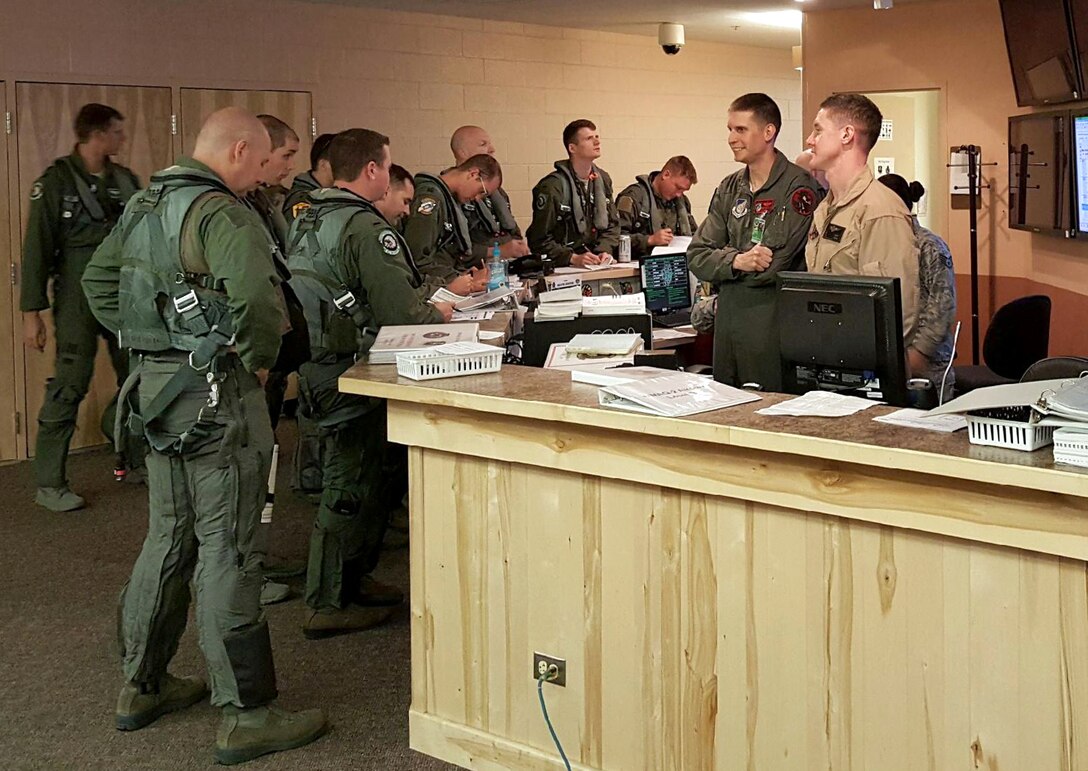 EIELSON AIR FORCE BASE, Alaska - U.S. military aviators from several service braches make final preparations prior to one of the first live, virtual and constructive (LVC) missions during Northern Edge 2015. LVC enables live participants in Alaska to directly engage and interact with virtual aviators operating from home station simulators, and constructive computer-generated forces to provide more robust training scenarios. Northern Edge 2015 is Alaska's premier joint training exercise designed to practice operations, tactics, techniques and procedures as well as enhance interoperability among thousands of Airmen, Soldiers, Sailors, Marines and Coast Guardsmen from active-duty, Reserve and National Guard units. (Photo courtesy of Orlando Torres/Released)