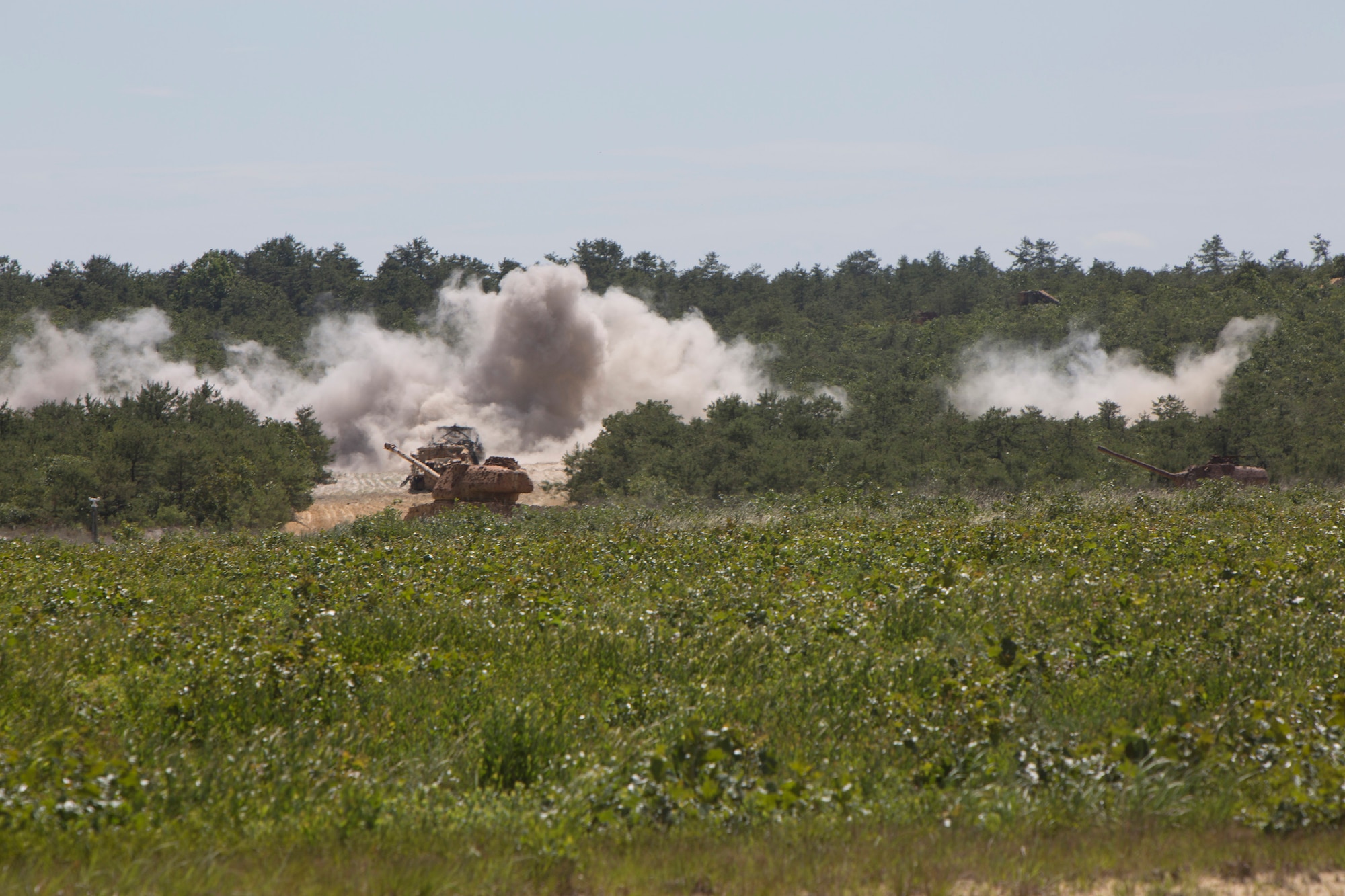 An A-10 Thunderbolt fires off an ammunition burst on a tank convoy as a part of Operation Morning Coffee at Warren Grove Gunnery Range, N.J., June 18, 2015. Operation Morning Coffee is a joint exercise with the New Jersey Army National Guard, Air National Guard and Marine Corps Reserve. (U.S. Marine Corps photo by Lance Cpl. Stanley Moy/Released)
