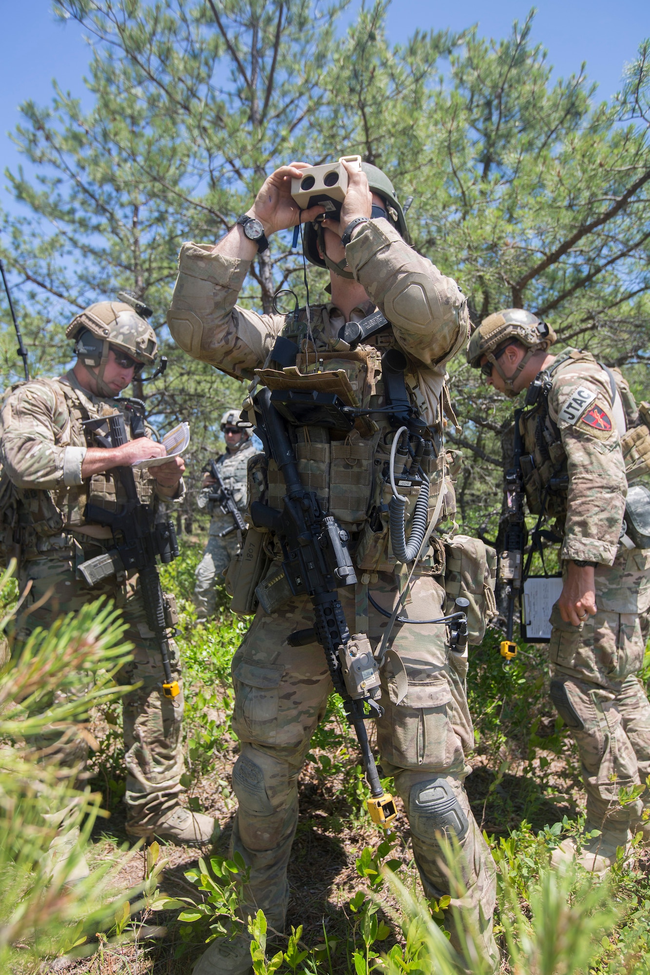 Airman 1st Class Michael Curley, 227th Air Support Operations Squadron, looks for an A-10 Thunderbolt in the sky during Operation Morning Coffee at Warren Groove Gunnery Range, N.J., June 17, 2015. Operation Morning Coffee a joint exercise with the New Jersey Army National Guard, Air National Guard and Marine Corps Reserve. (U.S. Marine Corps photo by Lance Cpl. Stanley Moy/Released)
