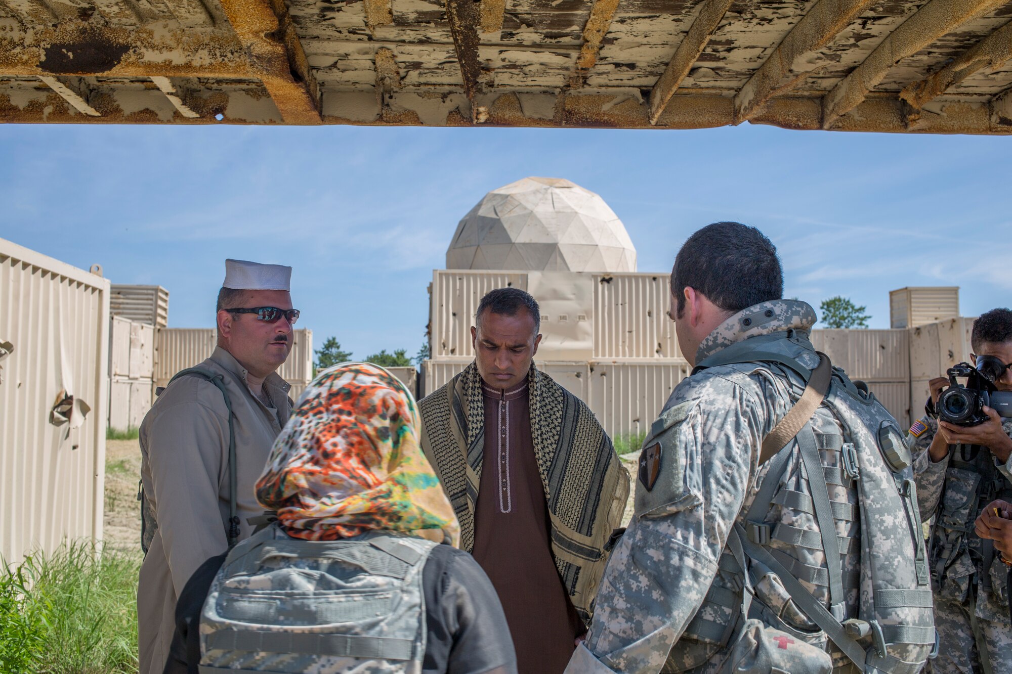 Soldiers from the 50th Infantry Brigade negotiate with a tribal leader as a part of Operation Morning Coffee at Warren Grover Gunnery Range, N.J., June 17, 2015. Operation Morning Coffee is a joint exercise with the New Jersey Army National Guard, Air National Guard and Marine Corps Reserve. (U.S. Marine Corps photo by Lance Cpl. Stanley Moy/Released)