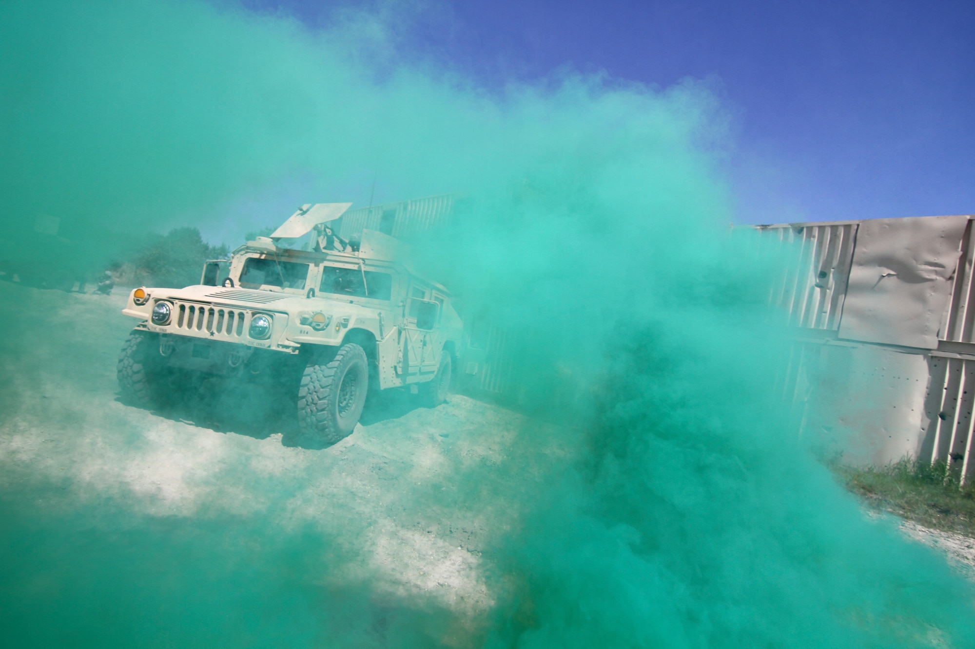 Smoke envelopes a Humvee from the New Jersey National Guard during a key leader engagement scenario on day two of Operation Morning Coffee, a joint exercise with the New Jersey Army and Air National Guard, Maryland Air National Guard, and the Marine Corps Reserve on Warren Grove Gunnery Range, N.J., June 17, 2015. (U.S. Air National Guard photo by Tech. Sgt. Matt Hecht/Released)
