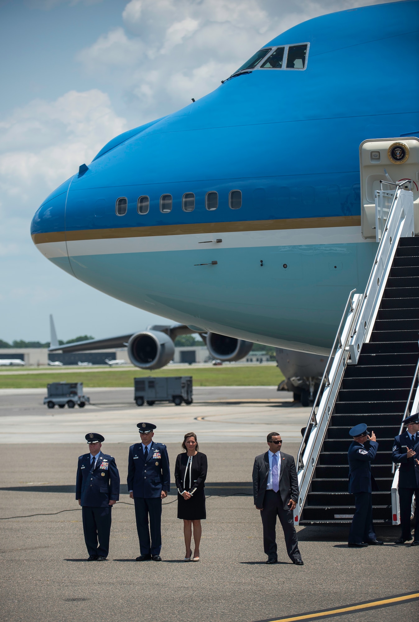 Col. Jeffrey DeVore, Joint Base Charleston commander, and Col. John Lamontagne, 437th Airlift Wing commander and his wife Becky, stand in front of Air Force One June 26, 2015 at JB Charleston, S.C. The President and First Lady attended the funeral services of Rev. Clementa Pinckney at the College of Charleston TD Arena, where President Obama delivered the eulogy. Vice President Joe Biden and Dr. Jill Biden also attended. Reverend Pinckney was one of nine people fatally shot June 17, 2015 week during a Bible study at Emanuel AME Church in Downtown Charleston. (U.S. Air Force photo/Senior Airman Jared Trimarchi) 