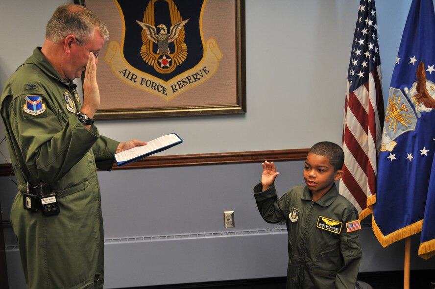 Col. Jeffrey Van Dootingh, commander of the 911th Airlift Wing, swears in Trenton Bentley as an honorary 2nd Lt. with the 911th AW here, June 24, 2015. Trenton, who was diagnosed with acute lymphoblastic leukemia in December 2014, was nominated by Children’s Hospital of Pittsburgh to be the 911th AW’s second ever Pilot for a Day. (U.S. Air Force photo by Senior Airman Marjorie A. Bowlden)
