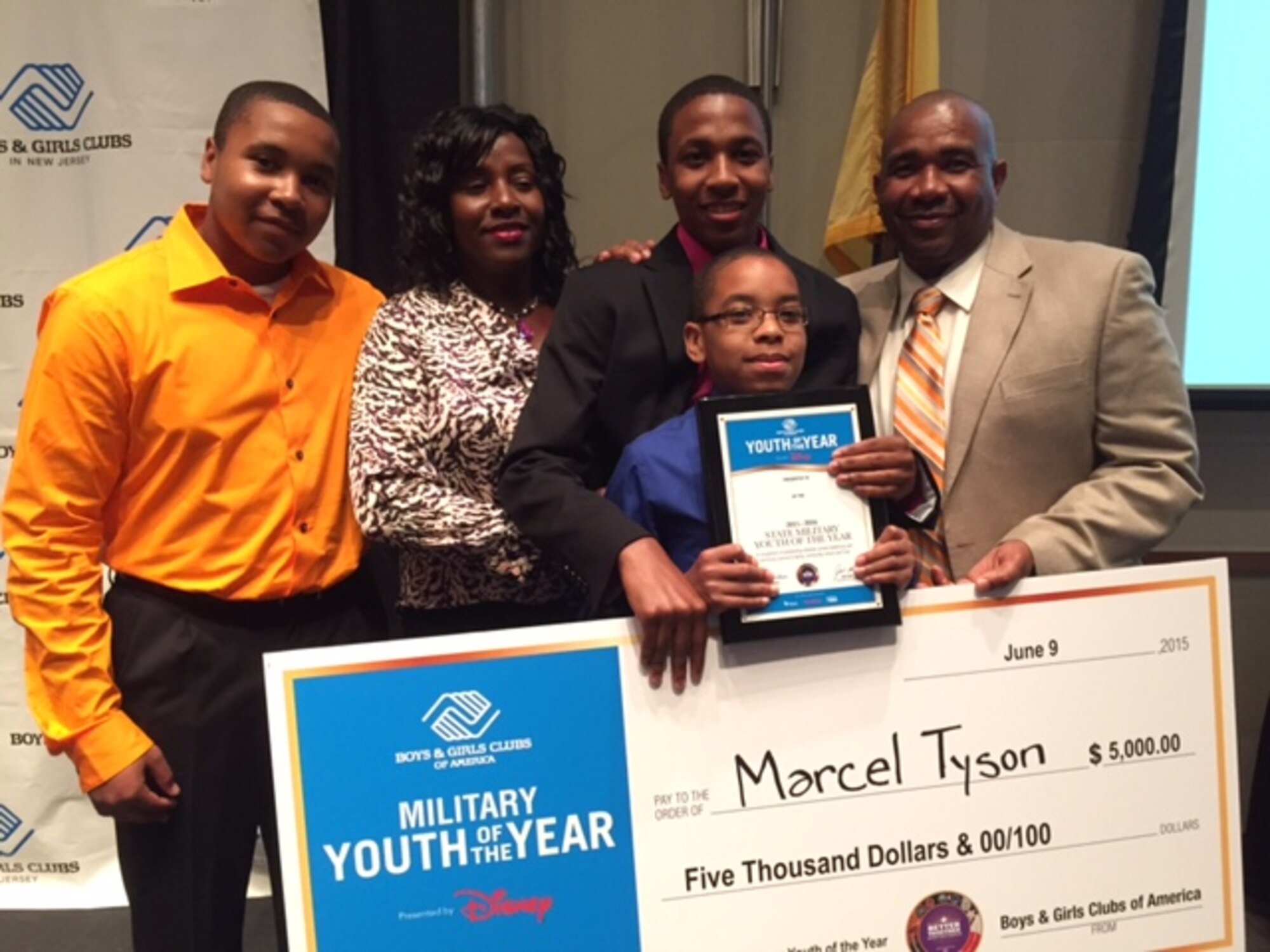 Marcel Tyson and his family take a photo with his scholarship check at Stockton University. Marcel received this scholarship for being the Boys and Girls Club of New Jersey's military youth of the year. (Courtesy photo) 