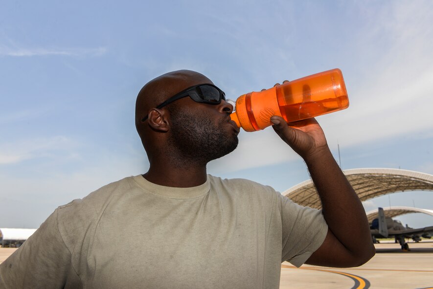 U.S. Air Force Senior Airman Tristian P. Franklin, 23d Aircraft Maintenance Squadron, hydrates to stay cool June 25, 2015, at Moody Air Force Base, Ga. Hydration is one of the main ways to combat heat-related illnesses. (U.S. Air Force photo by Senior Airman Sandra Marrero/Released)
