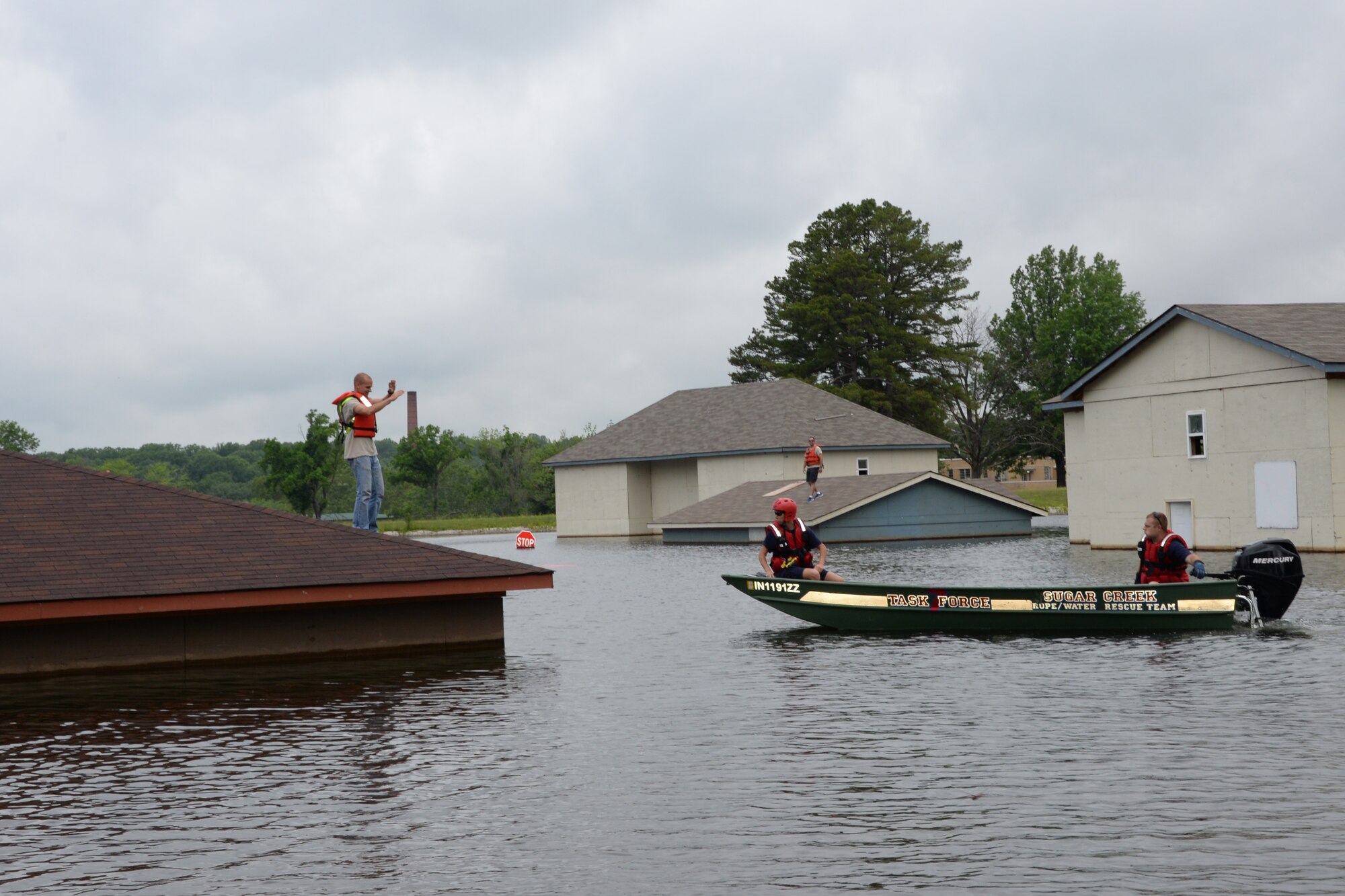 Members of the Vigo County Emergency Management Agency rescue flood victims during an exercise at Muscatatuck Urban Training Center, Ind., June 16, 2015. The 181st Intelligence Wing Airmen and Vigo County EMA partnered for a simulated hurricane disaster response exercise. (U.S. Air National Guard photo by Airman 1st Class Lonnie Wiram/Released)