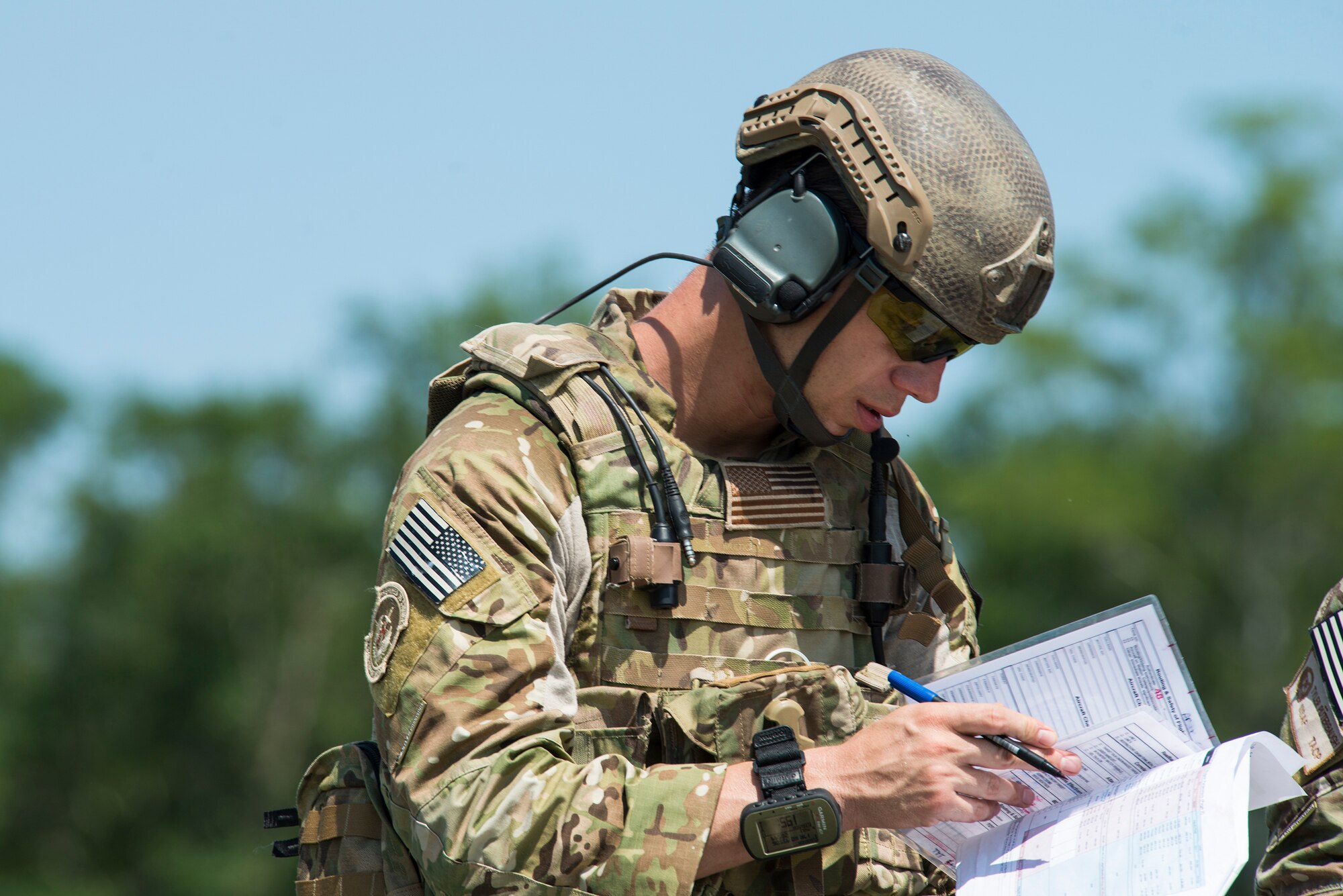 U.S. Air Force Tech. Sgt. Ron Tyson, 7th Air Support Operations Squadron tactical air control party, confirms coordinates during a joint training with the 74th Fighter Squadron June 18, 2015, on Grand Bay Bombing and Gunnery Range at Moody Air Force Base, Ga. TACPs from the 7th ASOS attended briefs, debriefs, academics lessons and controls training both with  simulated and real life munitions. (U.S. Air Force photo by Airman 1st Class Ceaira Tinsley/Released)