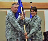 Col. Denise Cooper, right, accepts command of the 341st Mission Support Group from Col. Tom Wilcox, 341st Missile Wing commander, June 25 at the Grizzly Bend. (U.S. Air Force photo/John Turner)