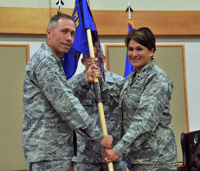 Col. Denise Cooper, right, accepts command of the 341st Mission Support Group from Col. Tom Wilcox, 341st Missile Wing commander, June 25 at the Grizzly Bend. (U.S. Air Force photo/John Turner)