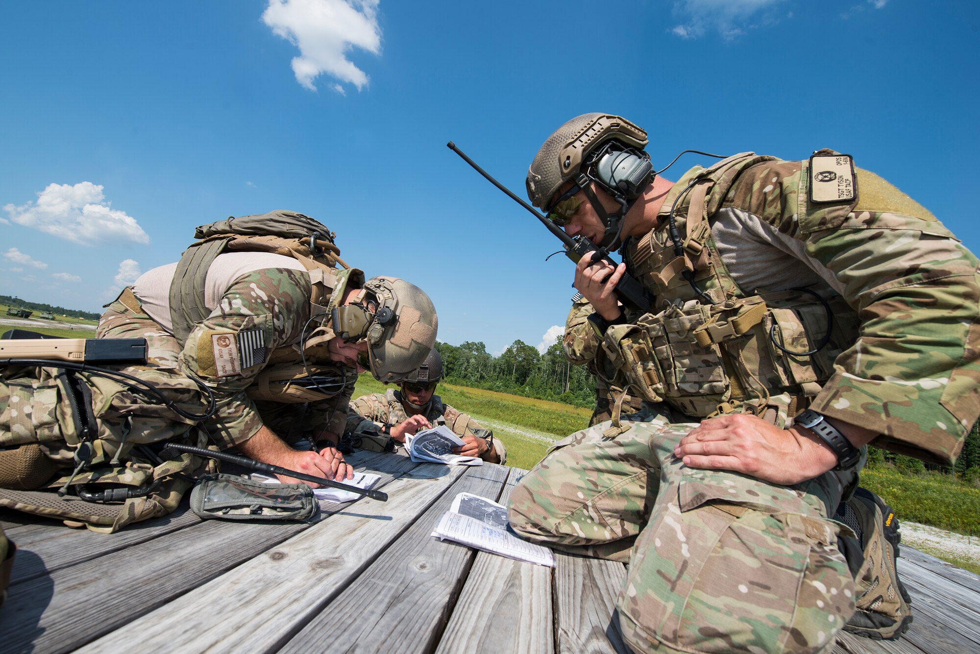 U.S. Air Force Tech. Sgt. Ron Tyson, 7th Air Support Operations Squadron tactical air control party, right, orders a strafe run while Staff Sgt. Tyler Puterbaugh, 7th ASOS TACP, finds the next target during a joint training June 18, 2015, on Grand Bay Bombing and Gunnery Range at Moody Air Force Base, Ga. The TACPs communicated target coordinates with the A-10C Thunderbolt pilots who performed strafe runs by firing .50-caliber rounds at the confirmed targets. The 74th FS and 7th ASOS formed a sister squadron close air support team and have trained together during IRON STRIKE and HUSTLER THUNDER. (U.S. Air Force photo by Airman 1st Class Ceaira Tinsley/Released)