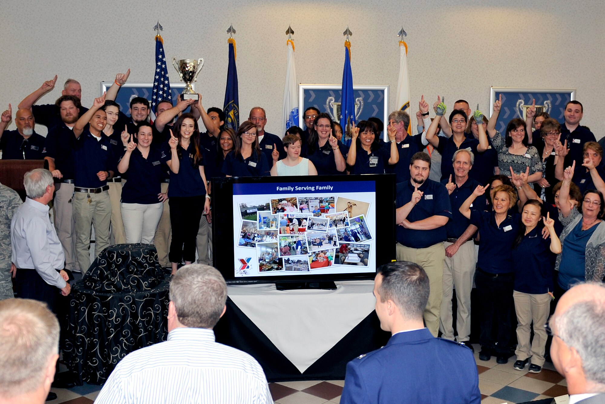 Associates from the Offutt Exchange hold up the Director’s Cup, signifying them as the best small Exchange in the world June 25, at Offutt Air Force Base, Nebraska. This is the second year in a row the Offutt Exchange system, which includes stores at Offutt Air Force Base, Lincoln and Camp Ashland, Nebraska., Camp Dodge and Des Moines Airport, Iowa and Sioux Falls, S.D.; has earned this award. (U.S. Air Force photo by Jeff Gates/Released)