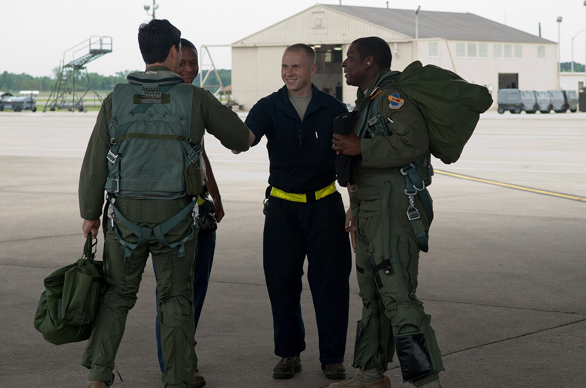 From left, 1st Lt. Jon Koritz, 335th Fighter Squadron pilot, Airmen 1st Class Thaddeus Kenebrew and Tyler Kimmell, both 4th Aircraft Maintenance Squadron crew chiefs, and 1st Lt. Desmond Ross, 336th FS weapons systems officer, shake hands before preparing for a flight, April 20, 2015, at Seymour Johnson Air Force Base, North Carolina. Air and ground crew share open dialogue between each other in case any maintenance issues with the aircraft arise. (U.S. Air Force photo/Airman Shawna L. Keyes)