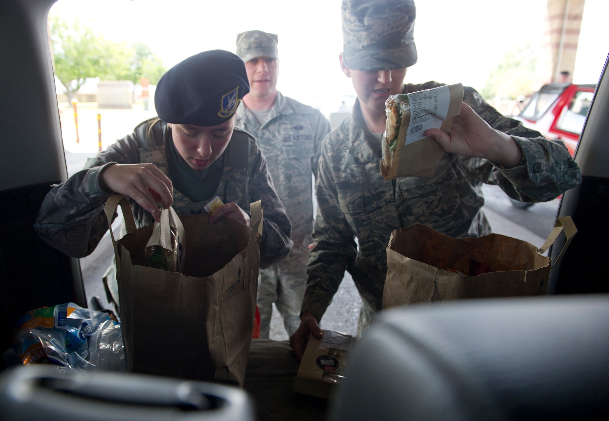 Members of the 49th Security Forces Squadron enjoy food supplied by Holloman’s Middle 2 as a part of the random acts of kindness program June 24, 2015 at Holloman Air Force Base , N.M. With the 49th SFS being the focus the Middle 2 decided they would supply the defenders, who are often stuck at the gate or in the office, without quality food and drink to ease the burden of not being able to depart from their post during shift. (Photo by U.S. Air Force Staff Sgt. Stacy Moless)