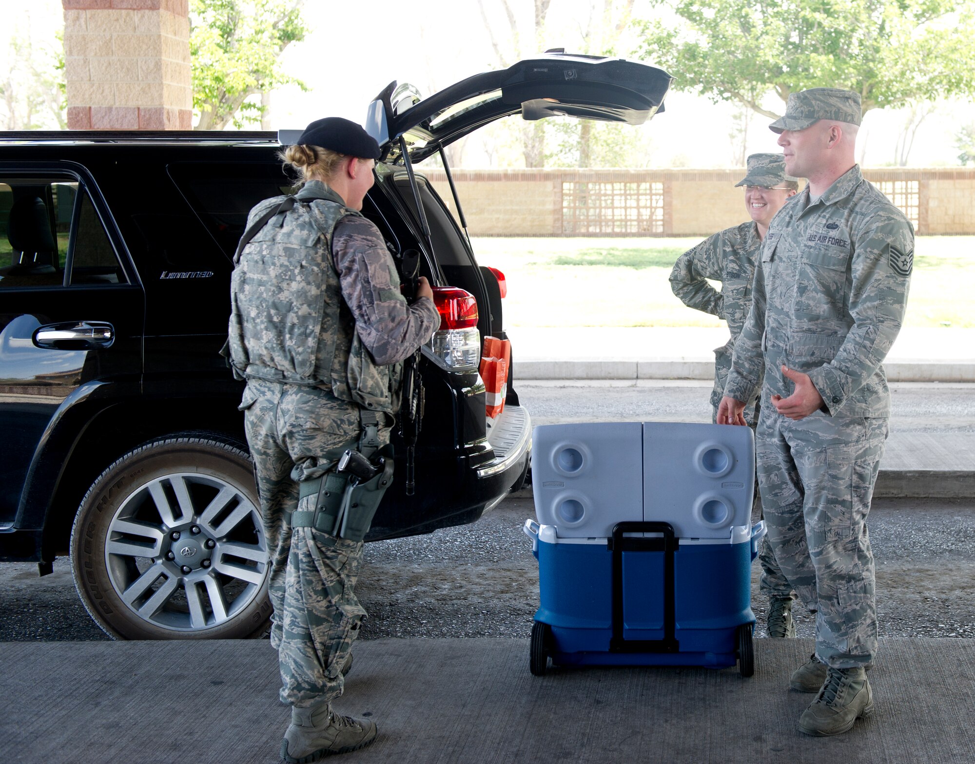 Members of the 49th Security Forces Squadron enjoy food supplied by Holloman’s Middle 2 as a part of the random acts of kindness program June 24, 2015 at Holloman Air Force Base , N.M. With the 49th SFS being the focus the Middle 2 decided they would supply the defenders, who are often stuck at the gate or in the office, without quality food and drink to ease the burden of not being able to depart from their post during shift. (Photo by U.S. Air Force Staff Sgt. Stacy Moless)